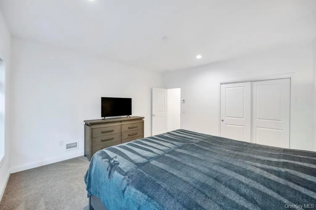 Carpeted bedroom with recessed lighting and a closet Carpeted bedroom with recessed lighting and a closet