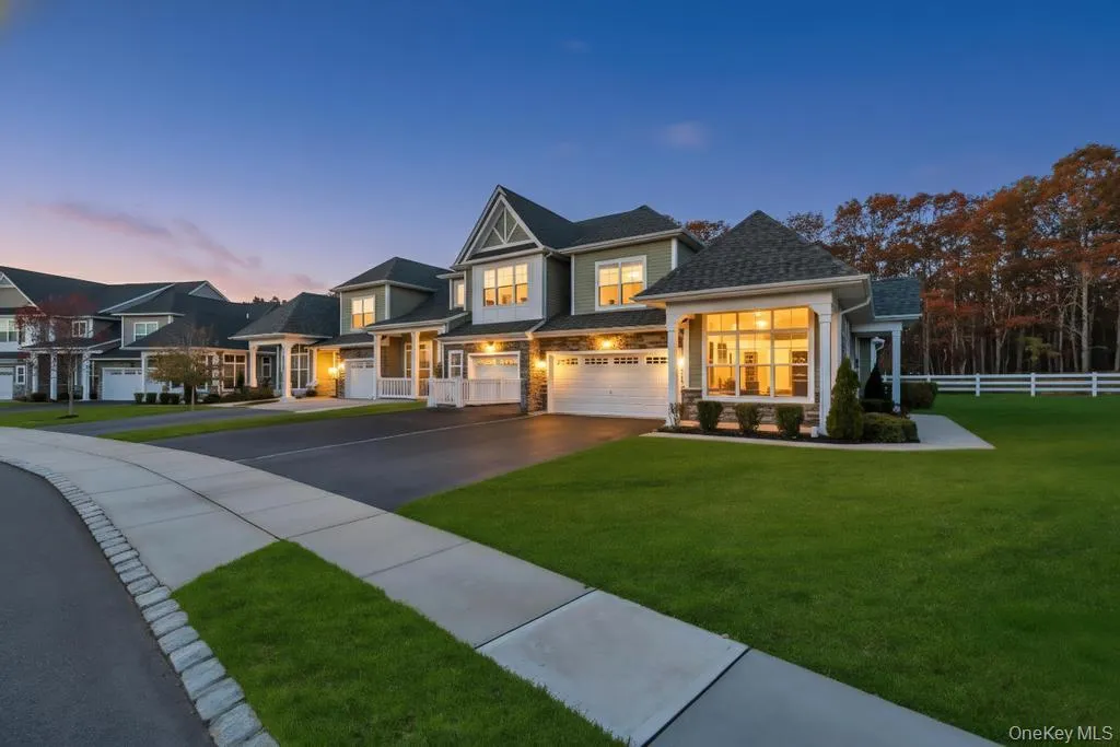 View of front of home featuring asphalt driveway and stone siding View of front of home featuring asphalt driveway and stone siding