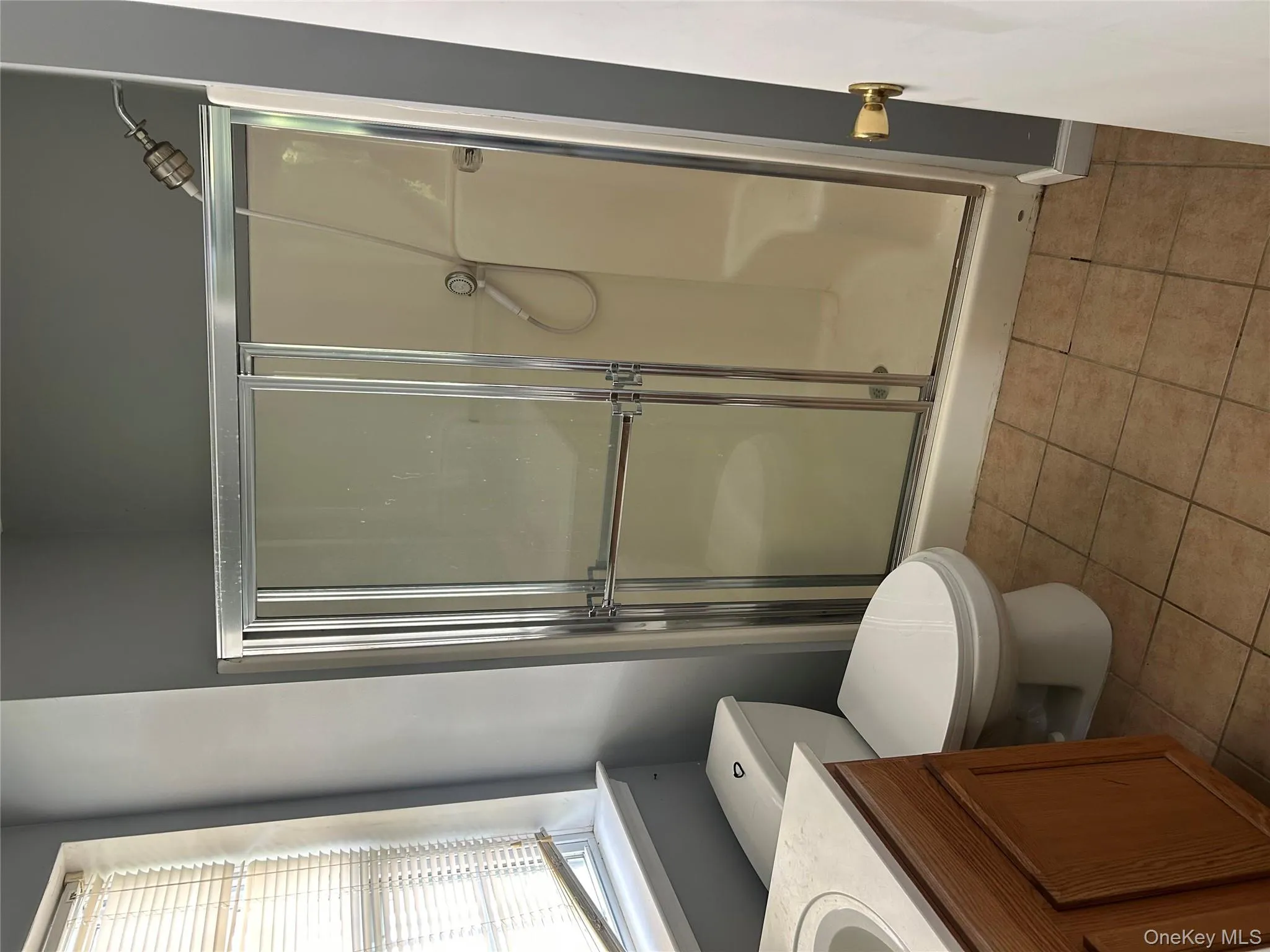 Full bath with light tile patterned floors, a stall shower, and vanity Full bath with light tile patterned floors, a stall shower, and vanity