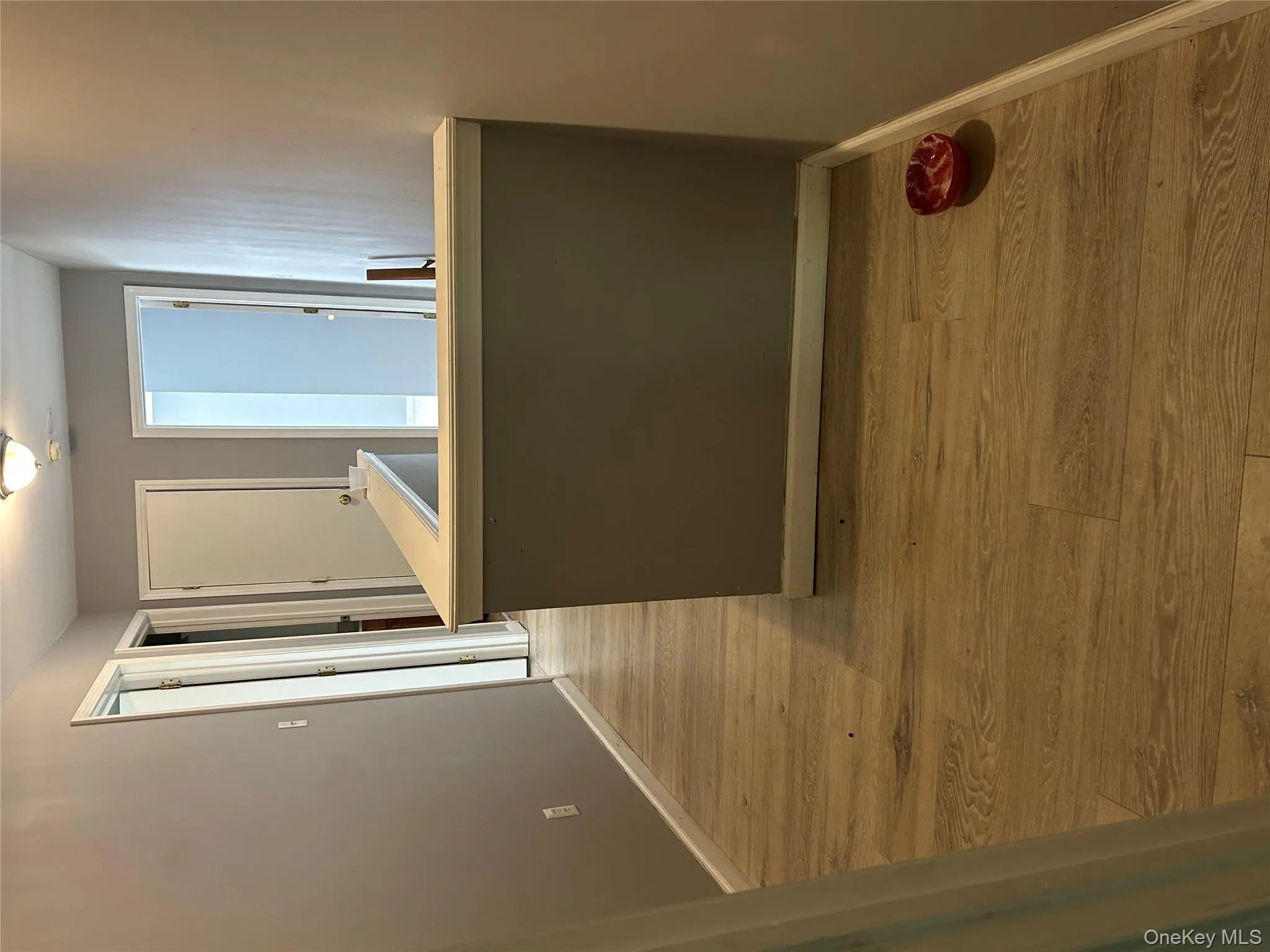Hallway featuring light wood-style flooring and an upstairs landing Hallway featuring light wood-style flooring and an upstairs landing