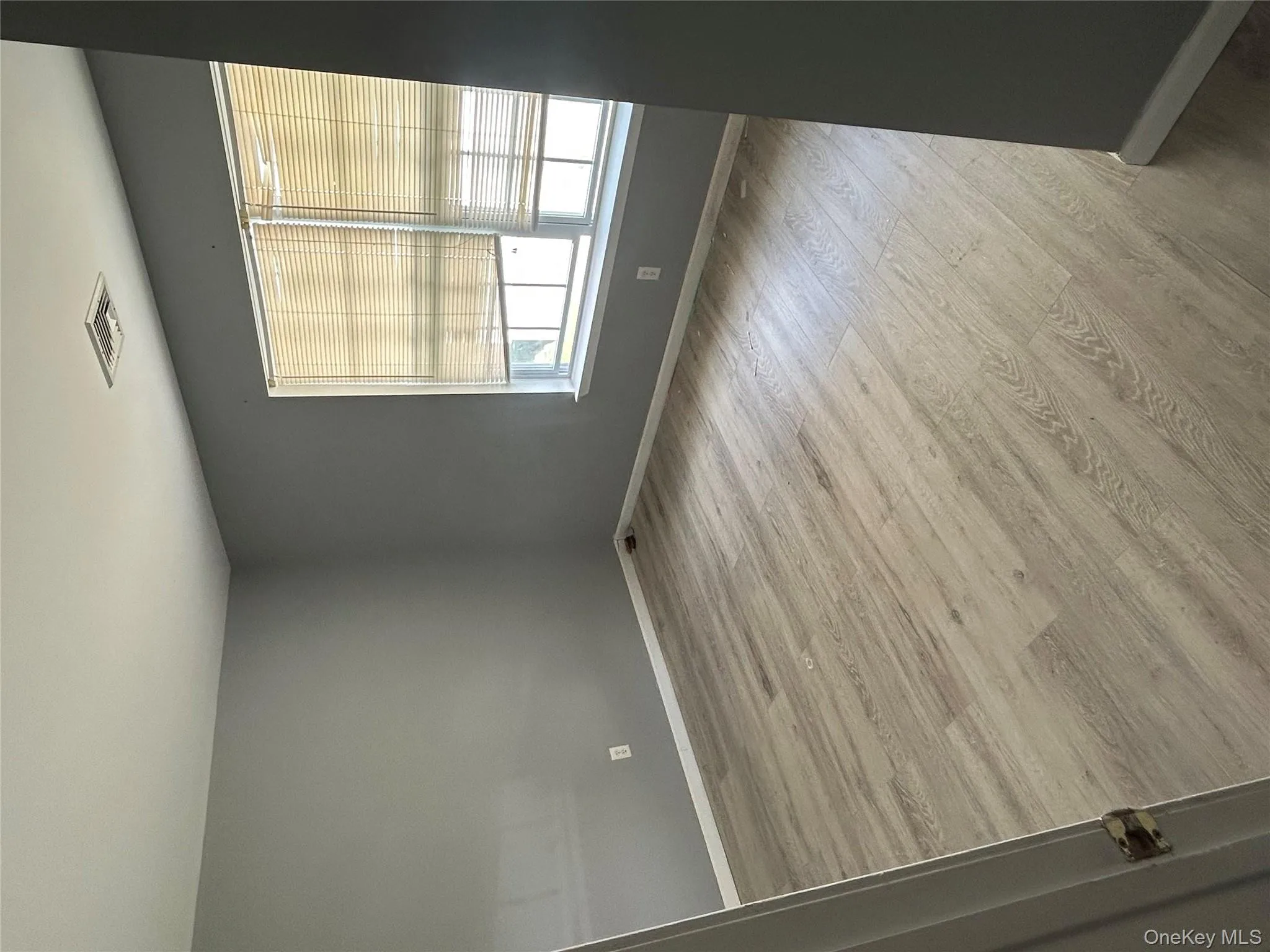 Spare room with light wood-type flooring and baseboards Spare room with light wood-type flooring and baseboards