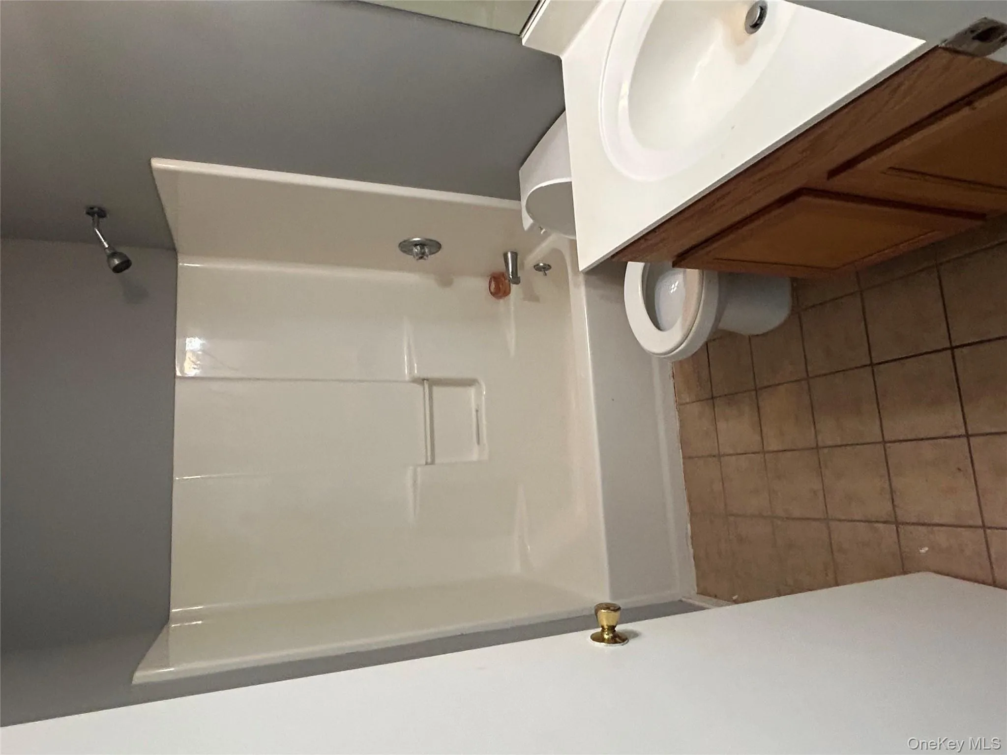 Full bath featuring vanity, dark tile patterned floors, and shower / washtub combination Full bath featuring vanity, dark tile patterned floors, and shower / washtub combination