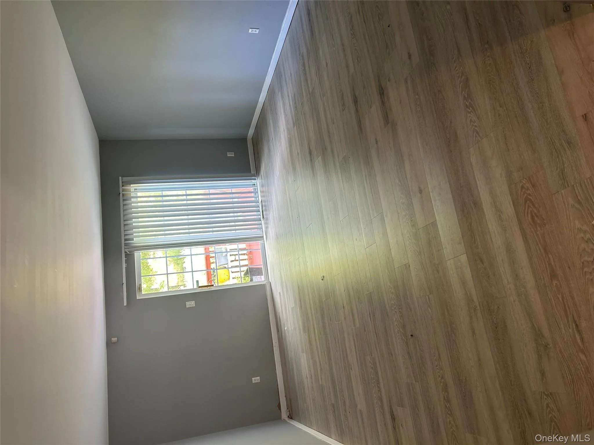 Spare room with light wood-style floors and baseboards Spare room with light wood-style floors and baseboards