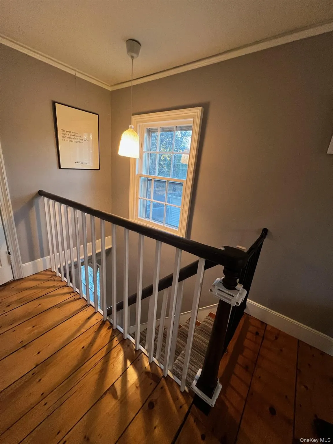 Staircase with ornamental molding and hardwood / wood-style floors Staircase with ornamental molding and hardwood / wood-style floors
