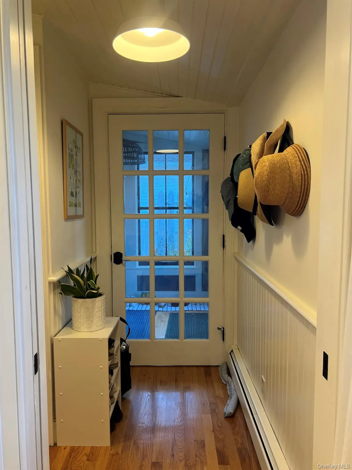 Doorway to outside with wood-type flooring, a baseboard heating unit, vaulted ceiling, and wooden ceiling Doorway to outside with wood-type flooring, a baseboard heating unit, vaulted ceiling, and wooden ceiling