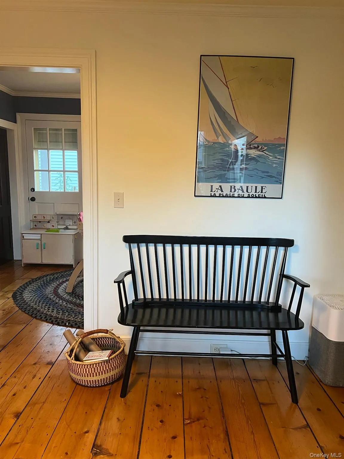 Living area featuring hardwood / wood-style flooring and crown molding Living area featuring hardwood / wood-style flooring and crown molding