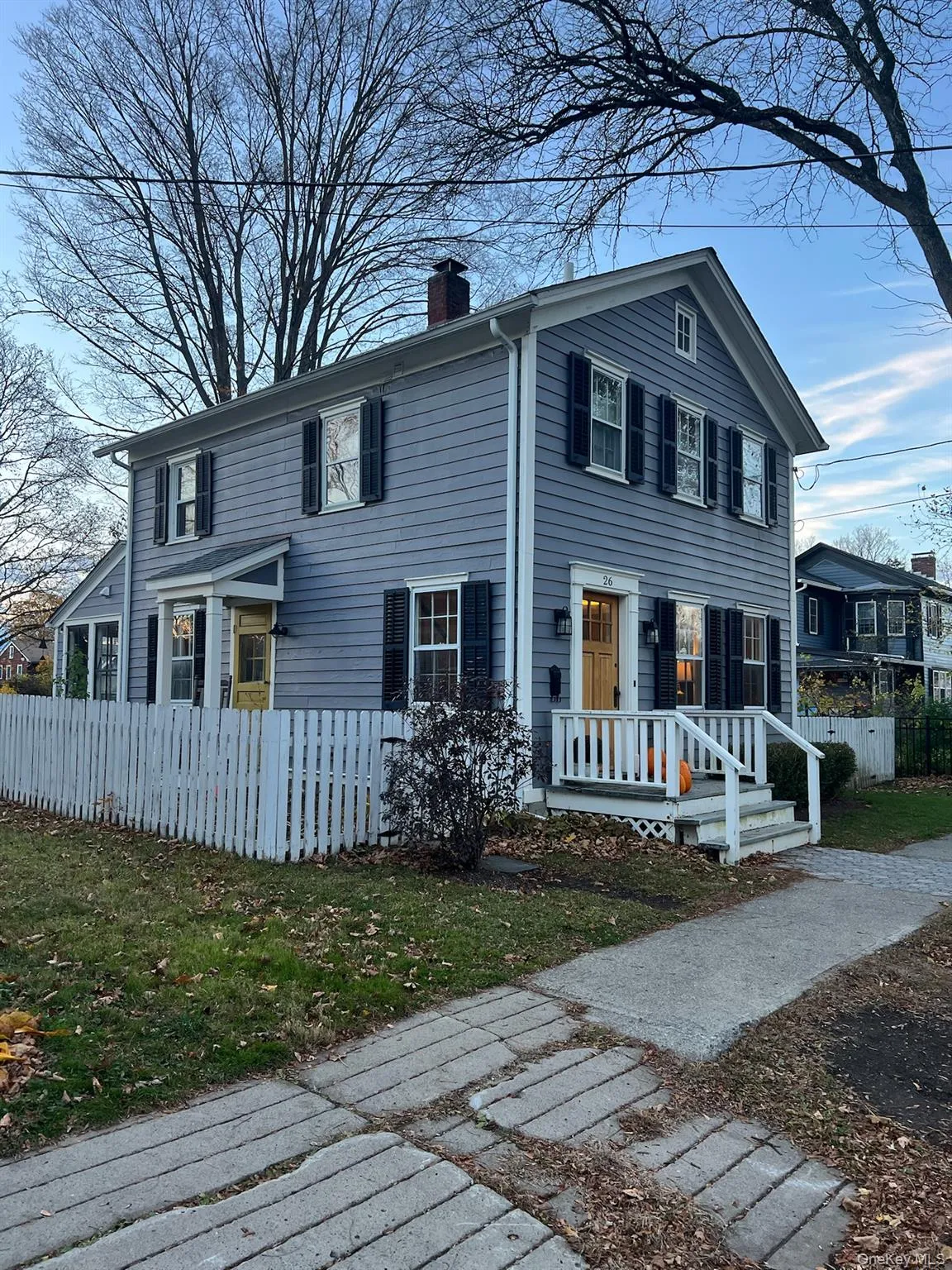 View of front of home with a fenced front yard and a chimney View of front of home with a fenced front yard and a chimney