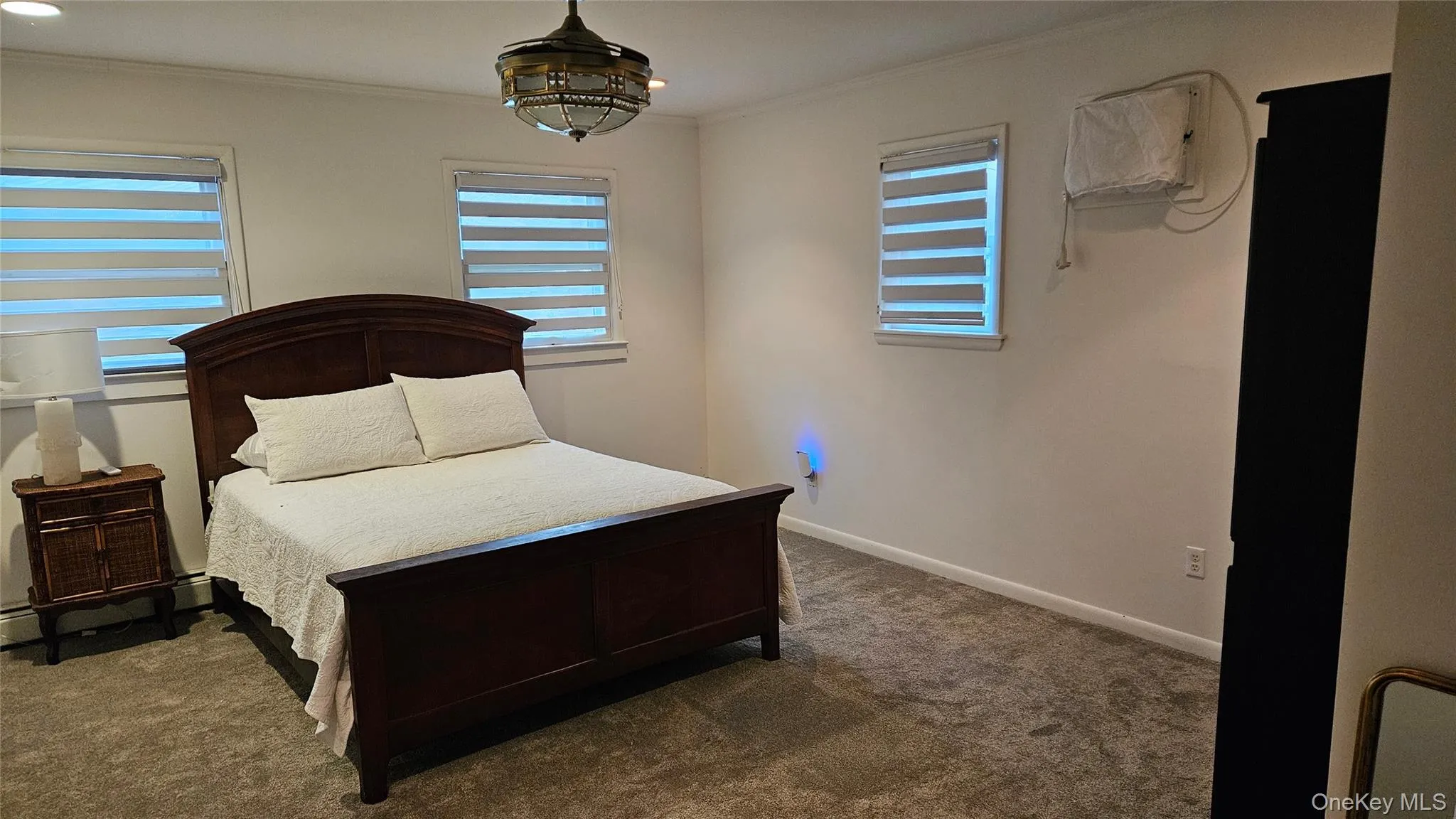 Bedroom featuring carpet flooring and crown molding Bedroom featuring carpet flooring and crown molding