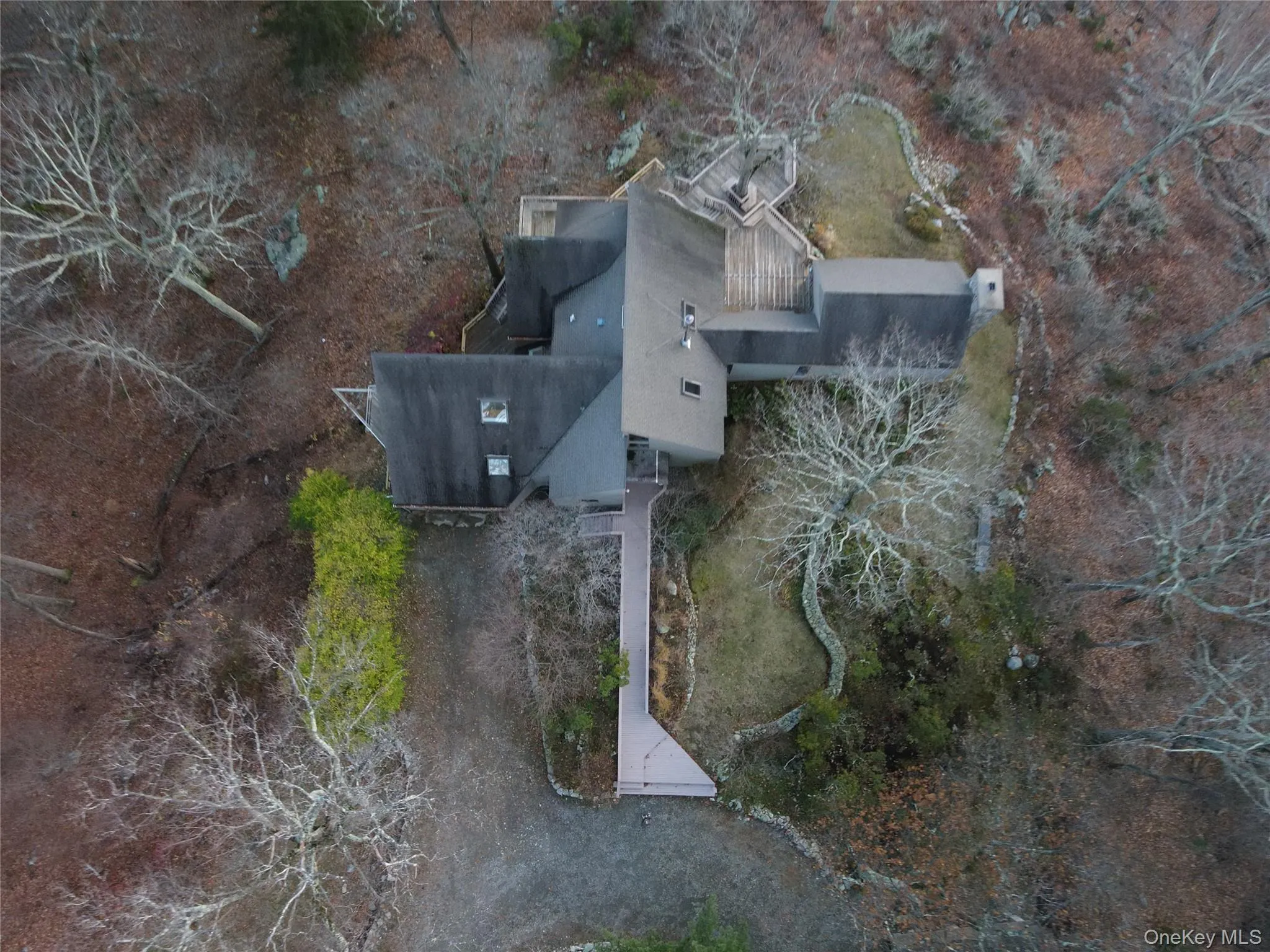 Aerial view of property and surrounding area featuring a tree filled landscape Aerial view of property and surrounding area featuring a tree filled landscape