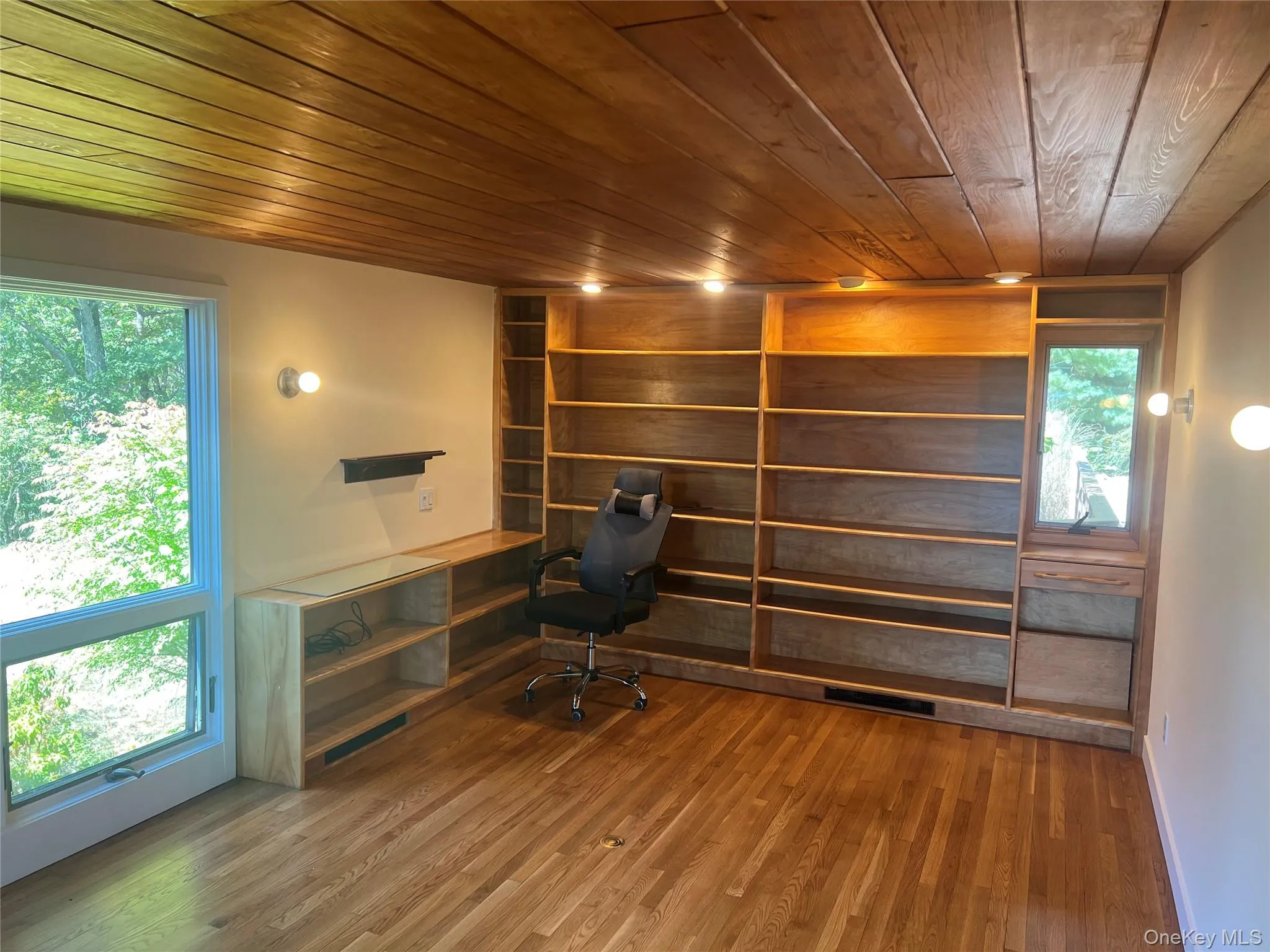 Unfurnished office with wood finished floors and wooden ceiling Unfurnished office with wood finished floors and wooden ceiling