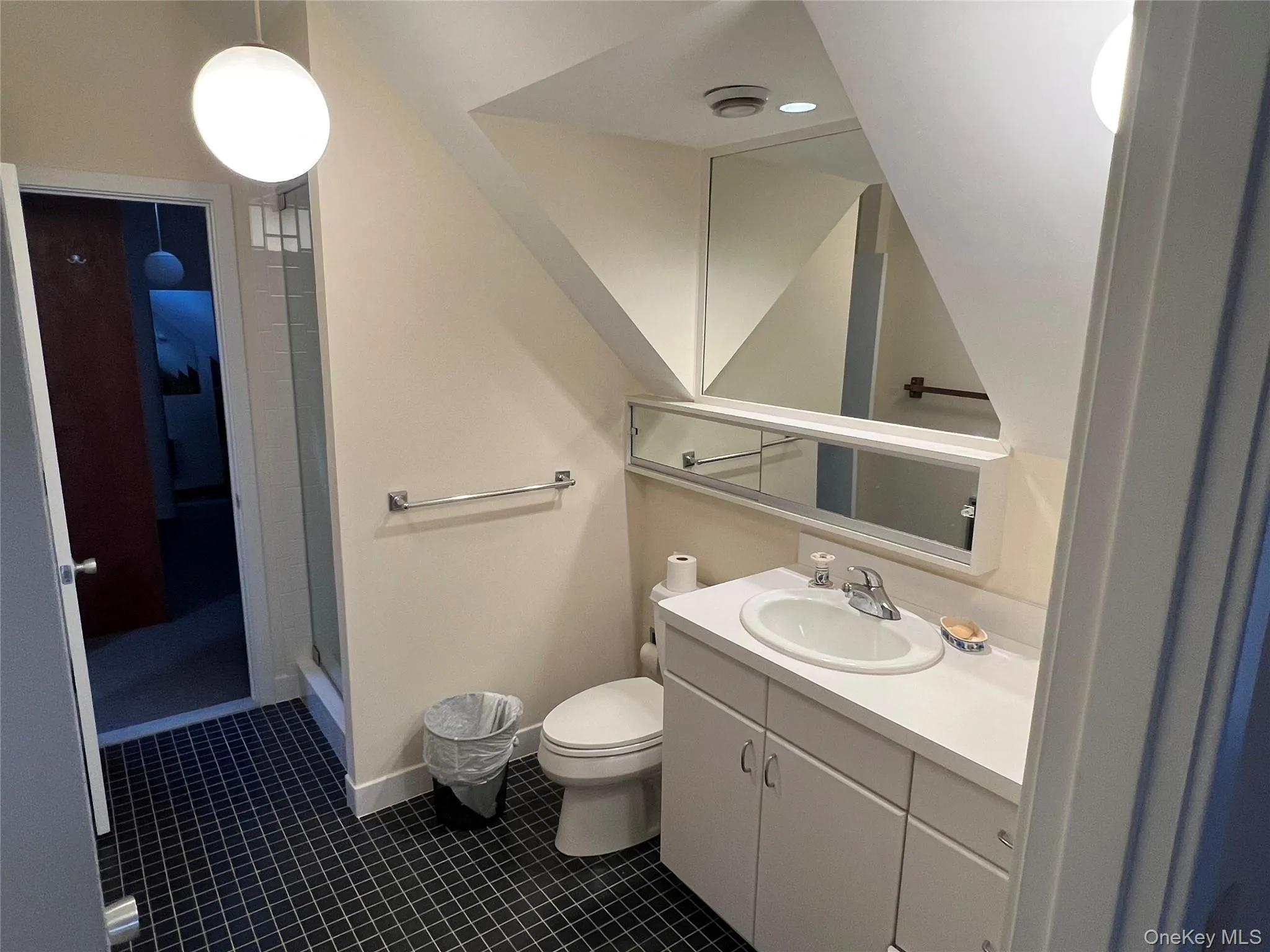 Full bath featuring vanity, dark tile patterned floors, and a shower stall Full bath featuring vanity, dark tile patterned floors, and a shower stall
