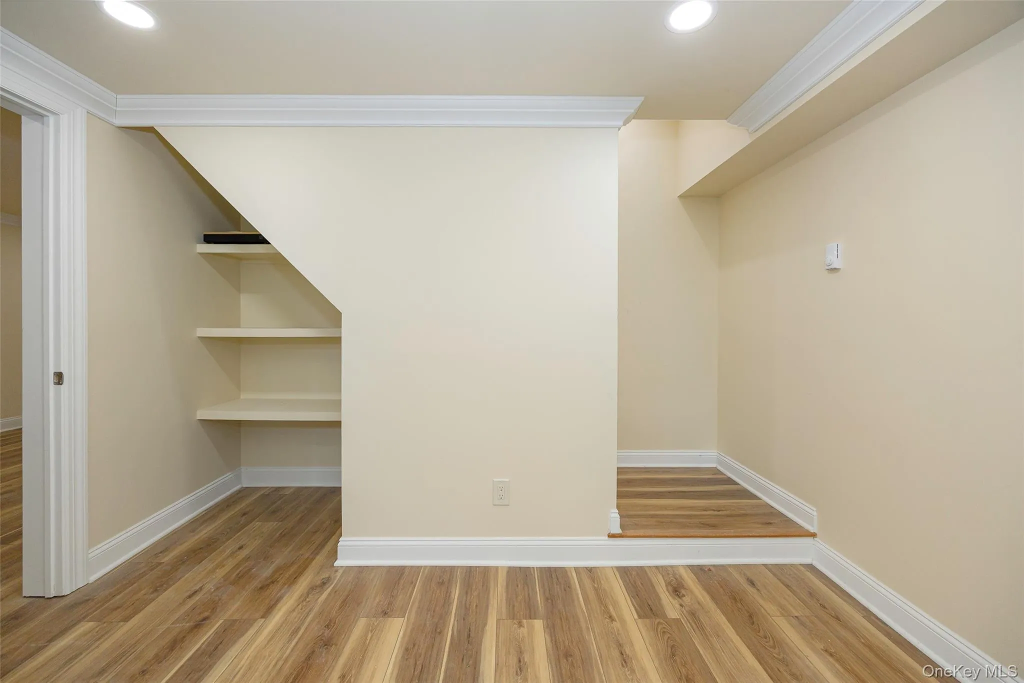 Unfurnished room with crown molding, light wood finished floors, and recessed lighting Unfurnished room with crown molding, light wood finished floors, and recessed lighting