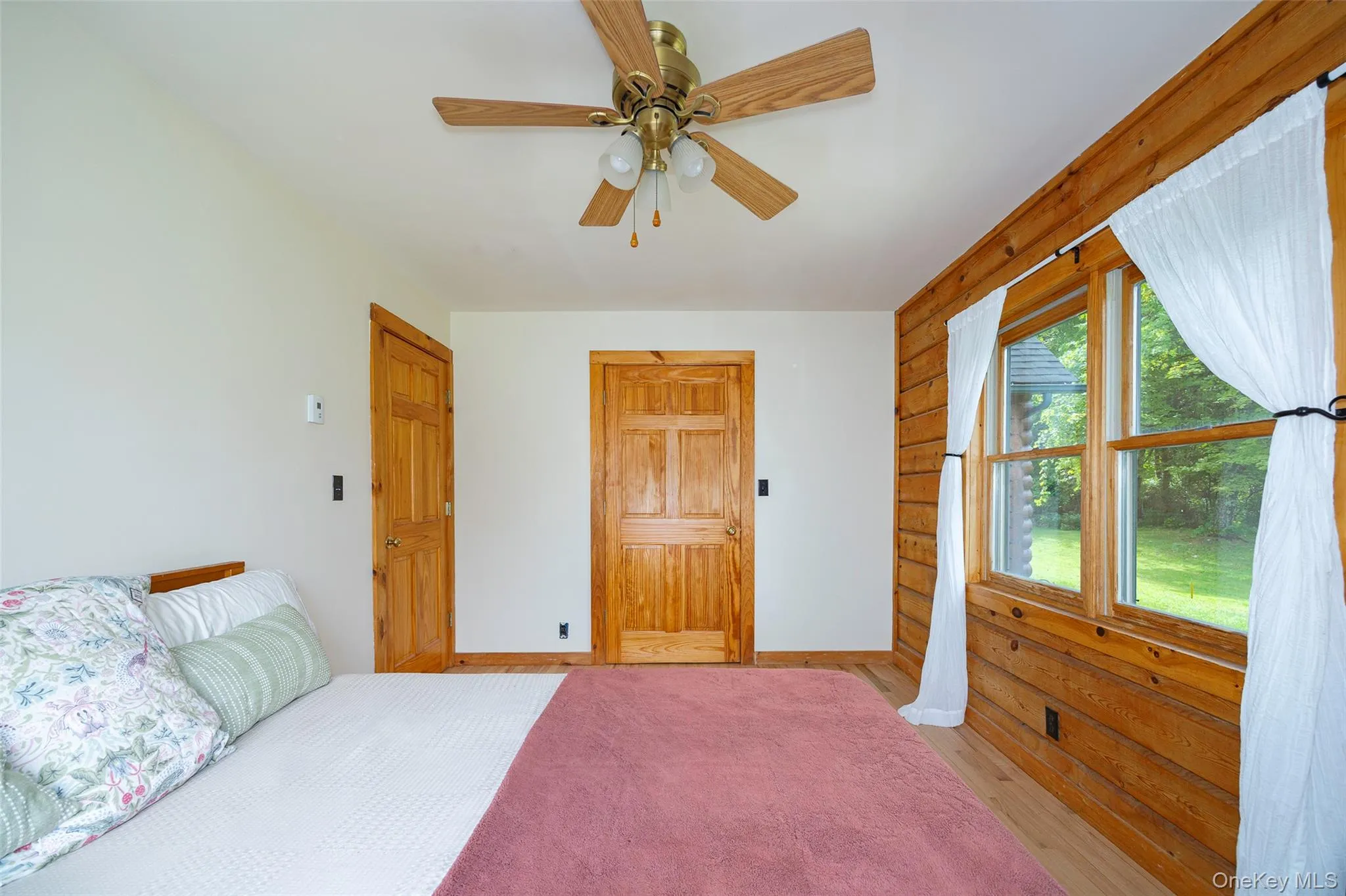 Bedroom featuring wood finished floors and ceiling fan Bedroom featuring wood finished floors and ceiling fan