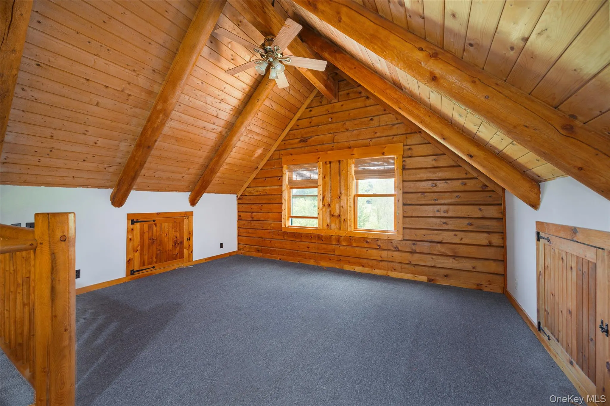 Additional living space featuring wood ceiling, carpet, and a ceiling fan Additional living space featuring wood ceiling, carpet, and a ceiling fan