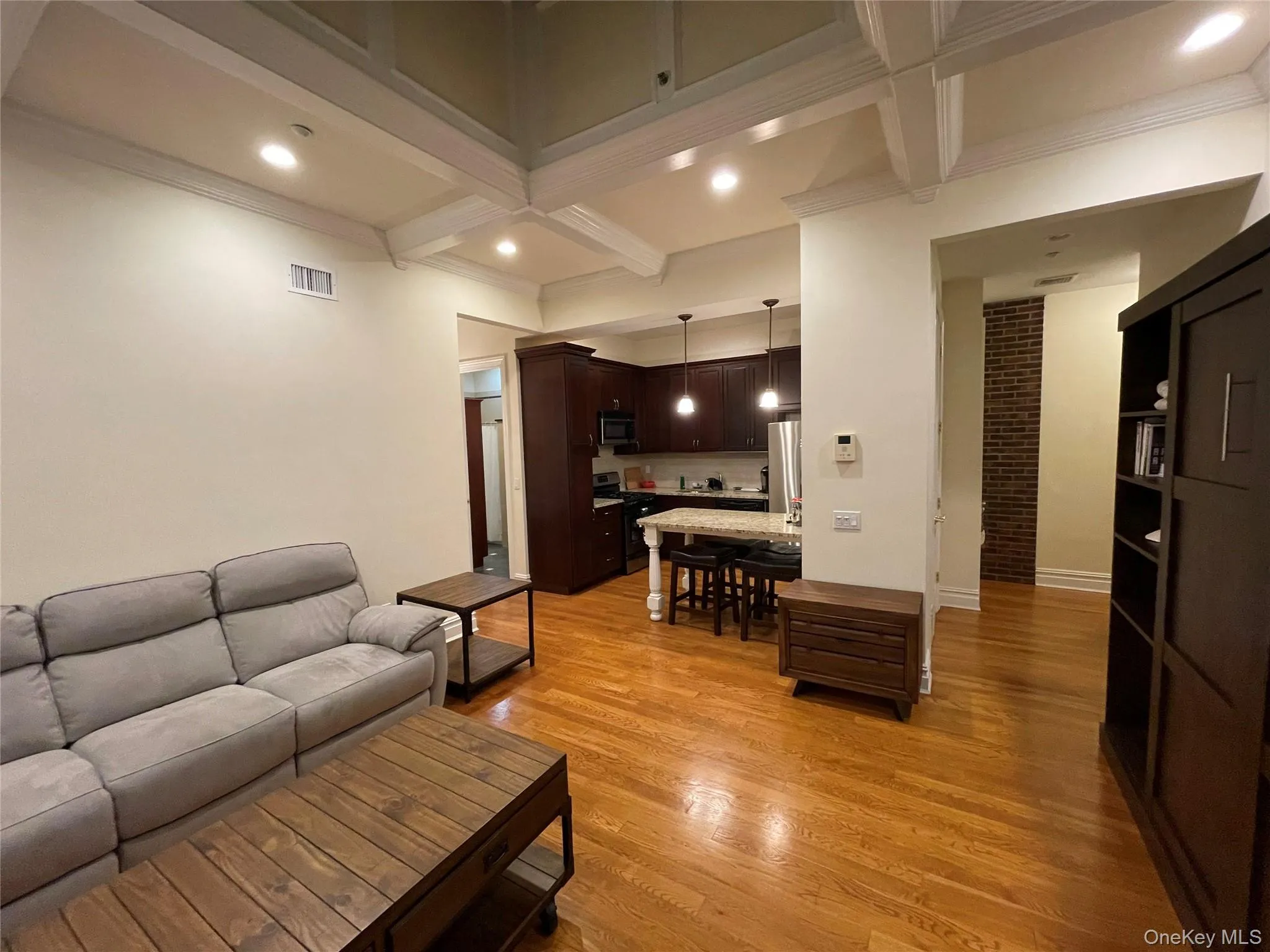 Living area featuring light wood-type flooring, beamed ceiling, coffered ceiling, recessed lighting, and crown molding Living area featuring light wood-type flooring, beamed ceiling, coffered ceiling, recessed lighting, and crown molding