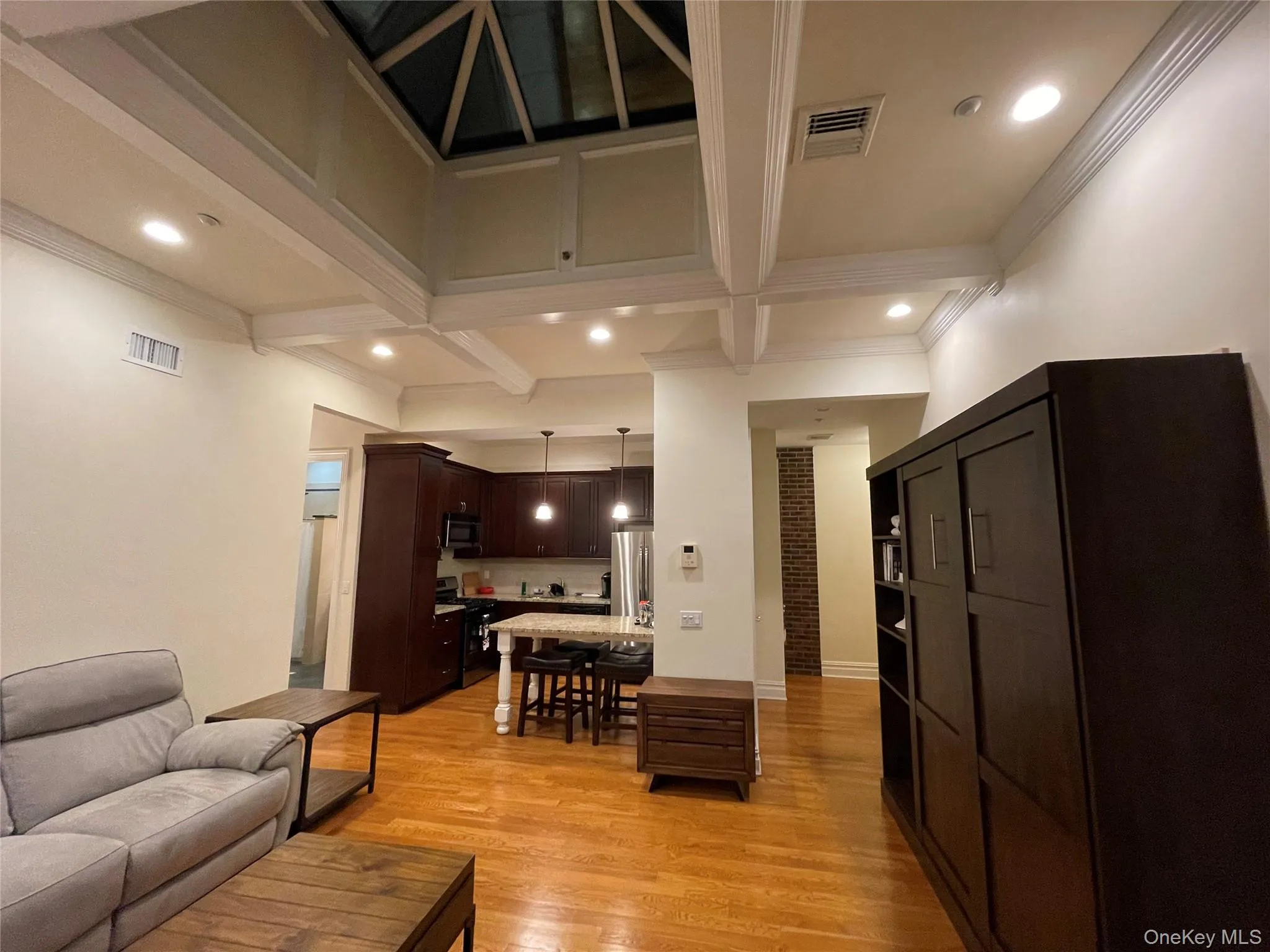 Living area with beamed ceiling, light wood finished floors, recessed lighting, coffered ceiling, and ornamental molding Living area with beamed ceiling, light wood finished floors, recessed lighting, coffered ceiling, and ornamental molding