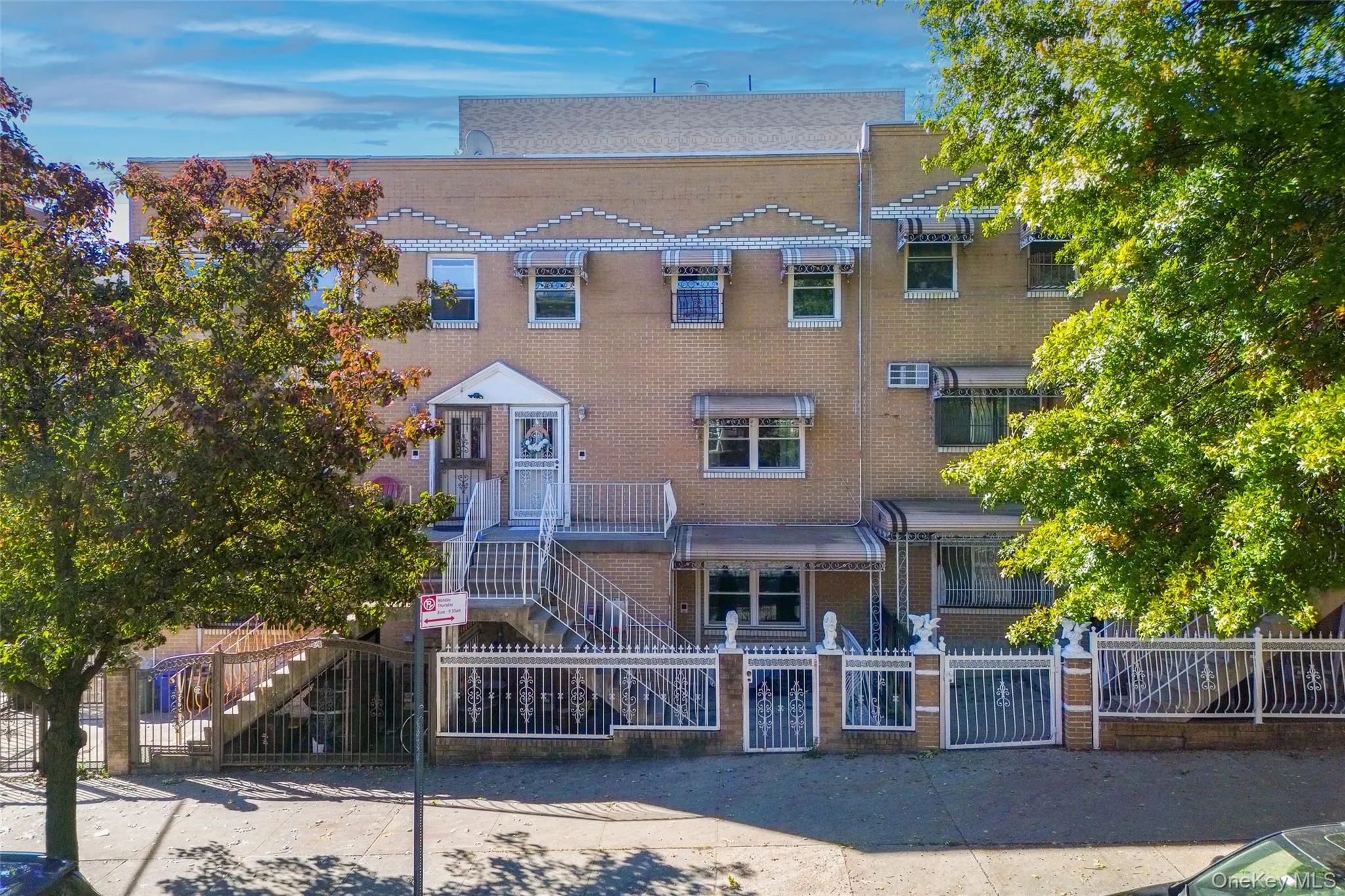 View of front of property featuring a gate, a fenced front yard, and brick siding View of front of property featuring a gate, a fenced front yard, and brick siding
