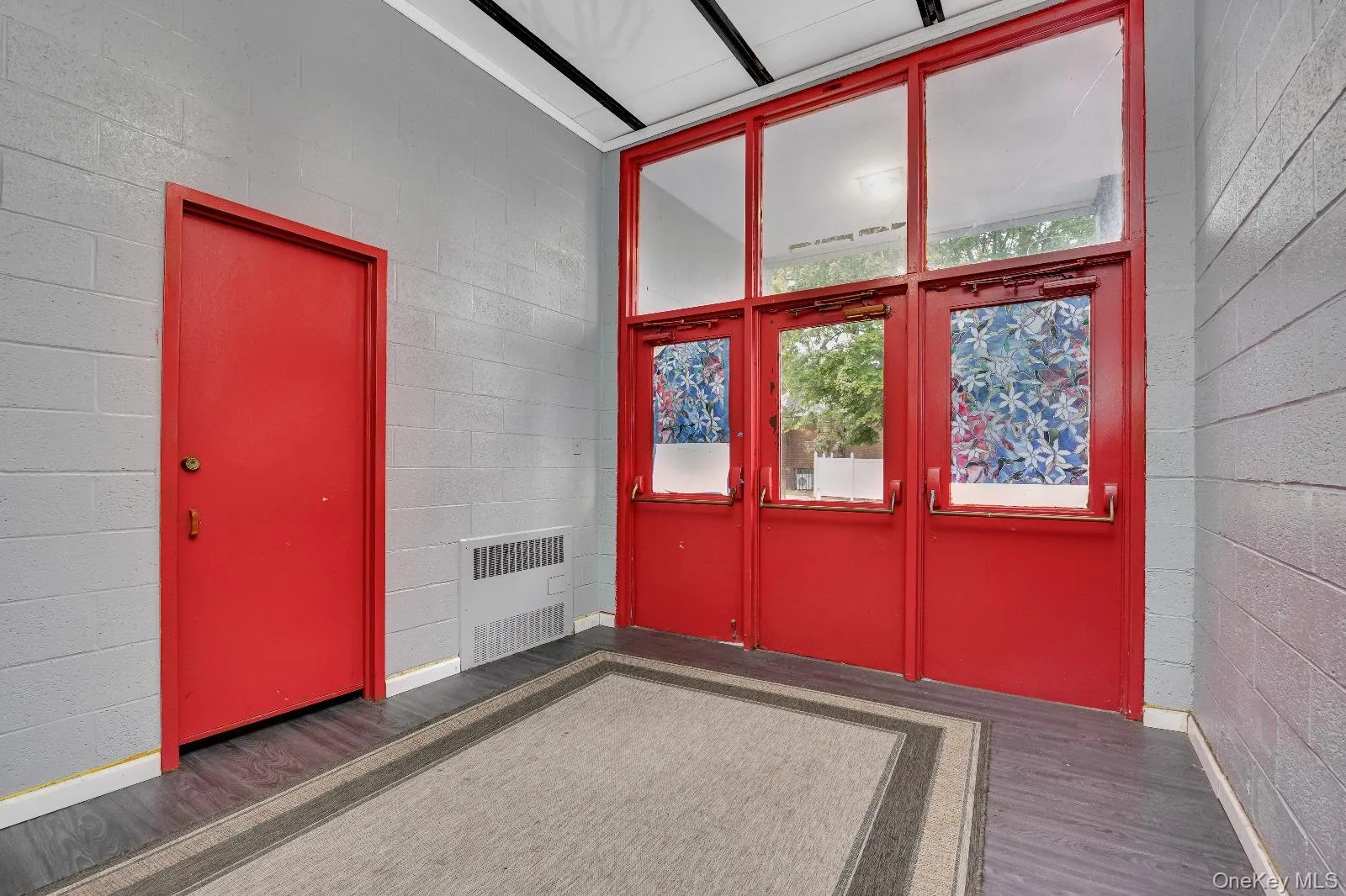 View of exterior entry featuring french doors and radiator heating unit View of exterior entry featuring french doors and radiator heating unit