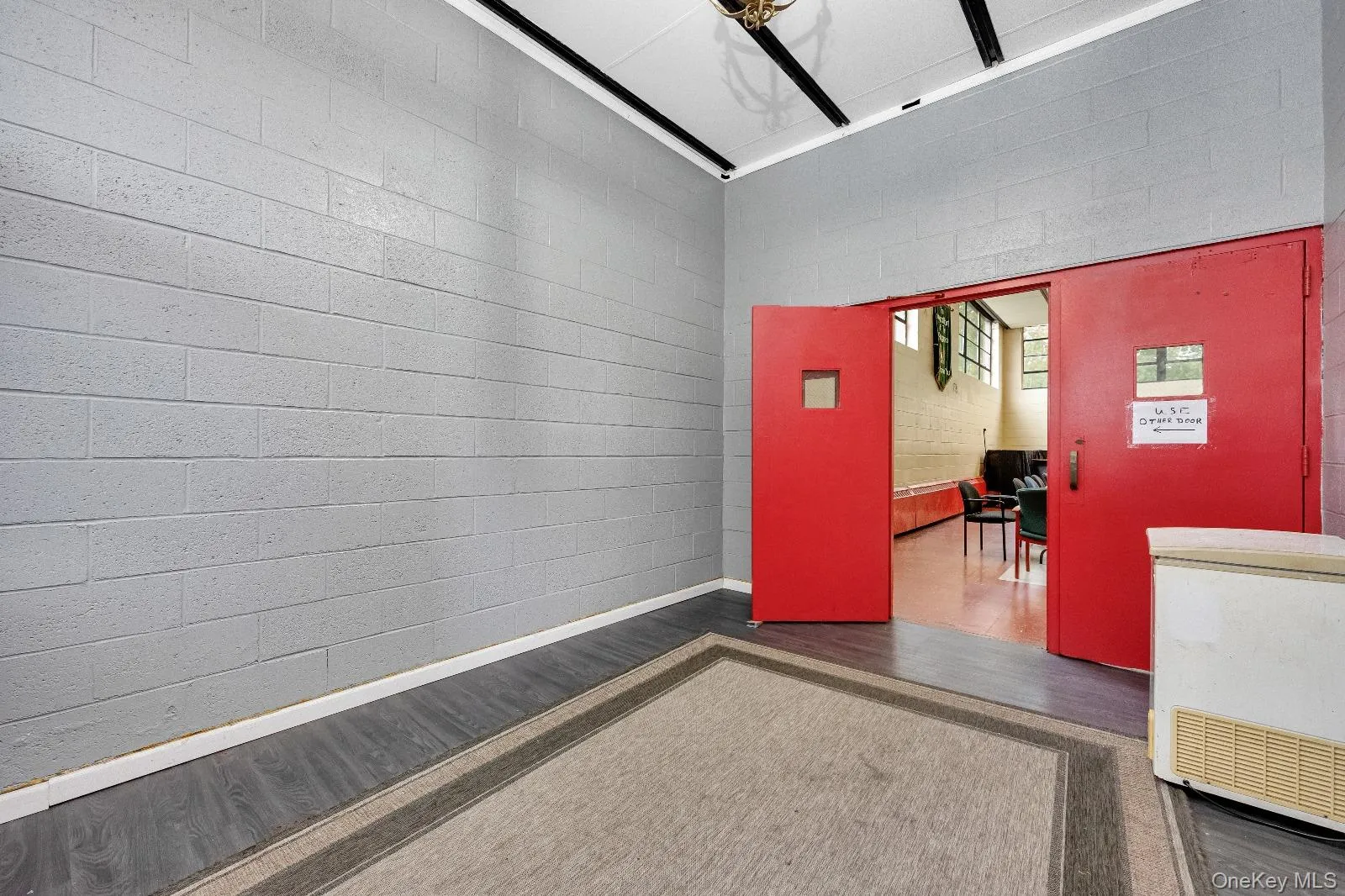 Empty room with wood finished floors and concrete block wall Empty room with wood finished floors and concrete block wall