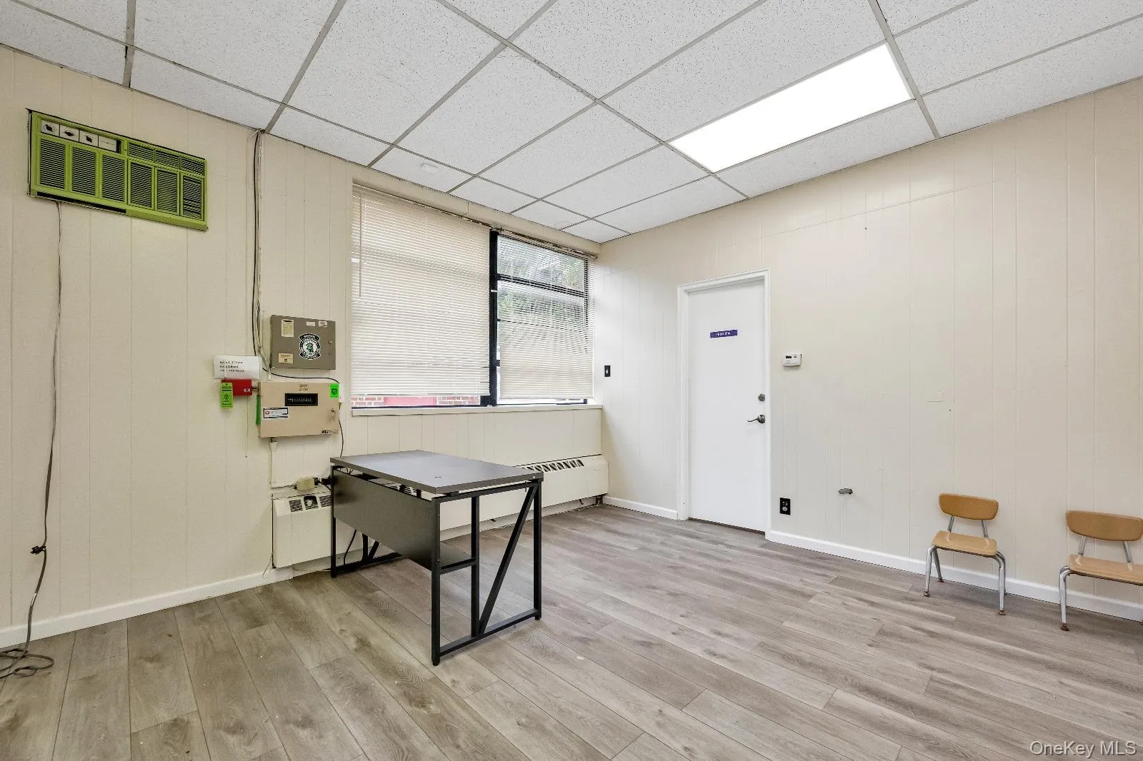 Office with wooden walls and a drop ceiling Office with wooden walls and a drop ceiling