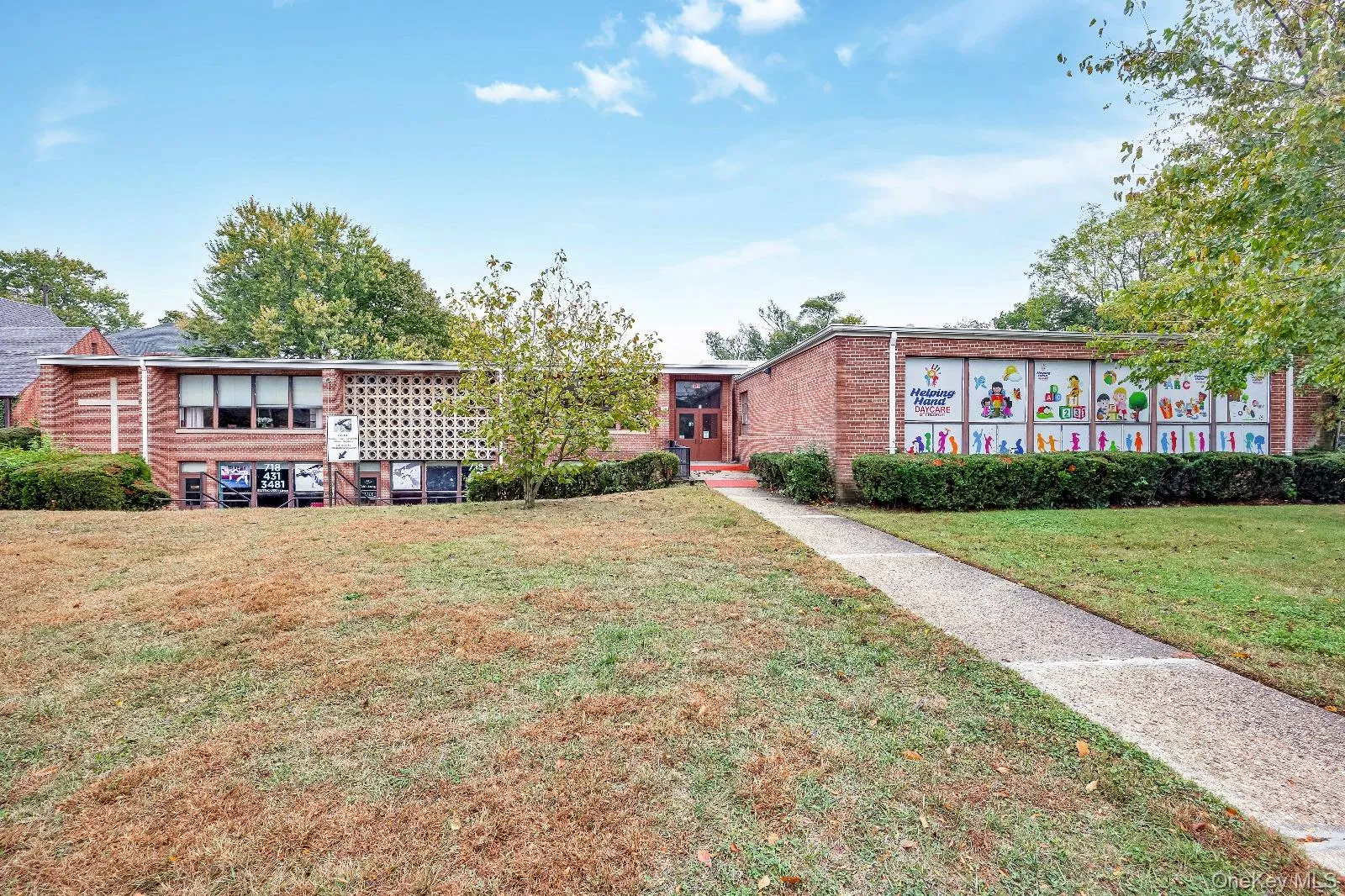 View of front facade with a front yard and brick siding View of front facade with a front yard and brick siding
