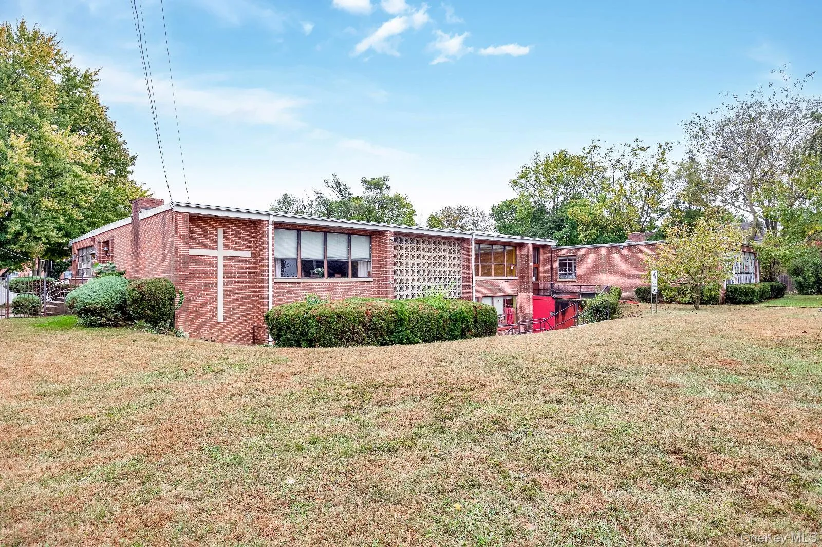 View of front of house with a front lawn and brick siding View of front of house with a front lawn and brick siding