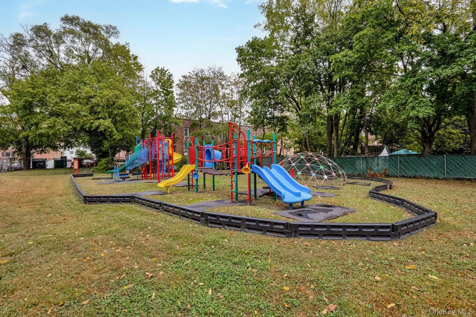 Community play area with view of scattered trees Community play area with view of scattered trees