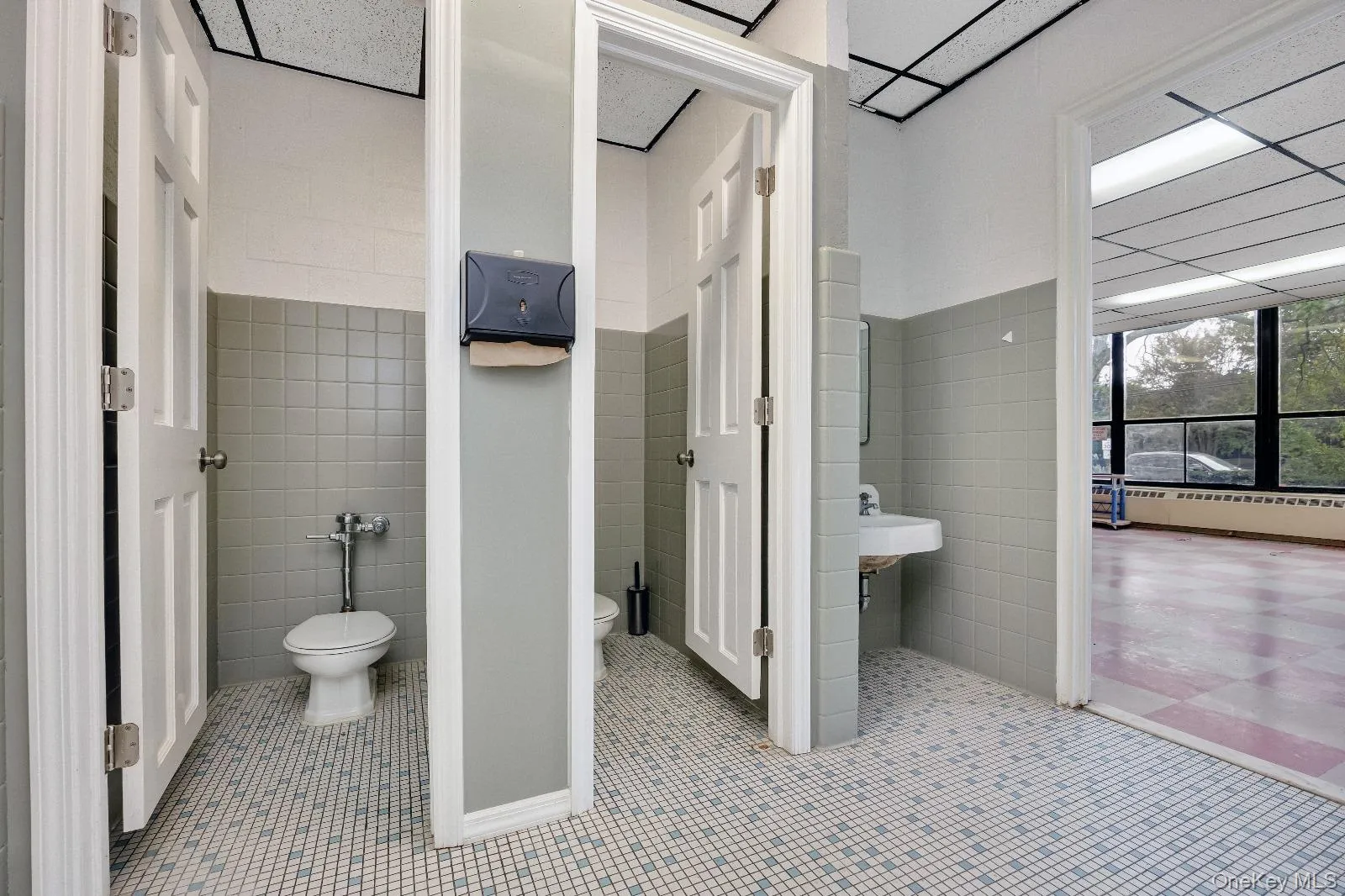 Bathroom with tile walls and light tile patterned flooring Bathroom with tile walls and light tile patterned flooring