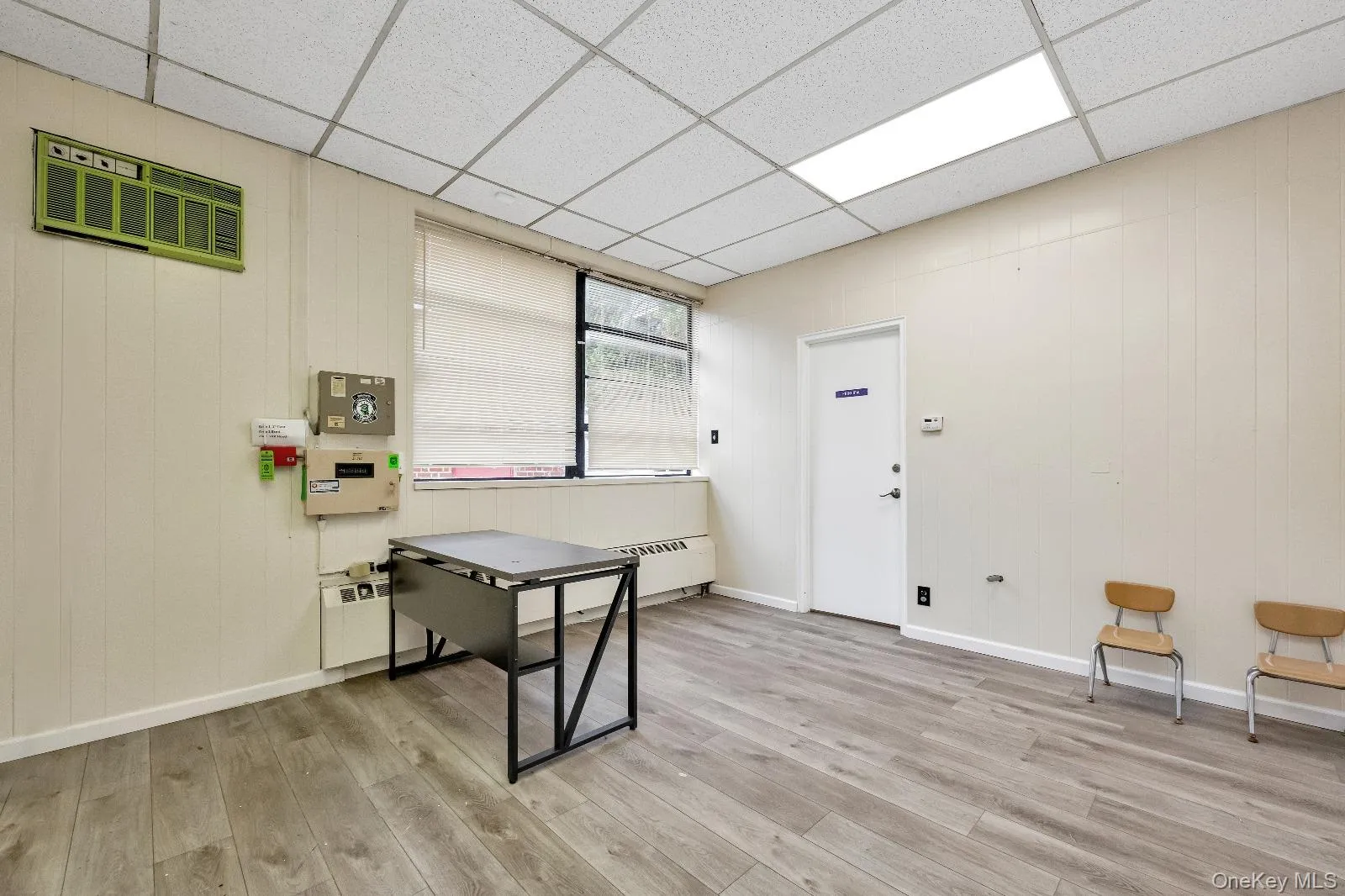 Office space with wood walls and a drop ceiling Office space with wood walls and a drop ceiling