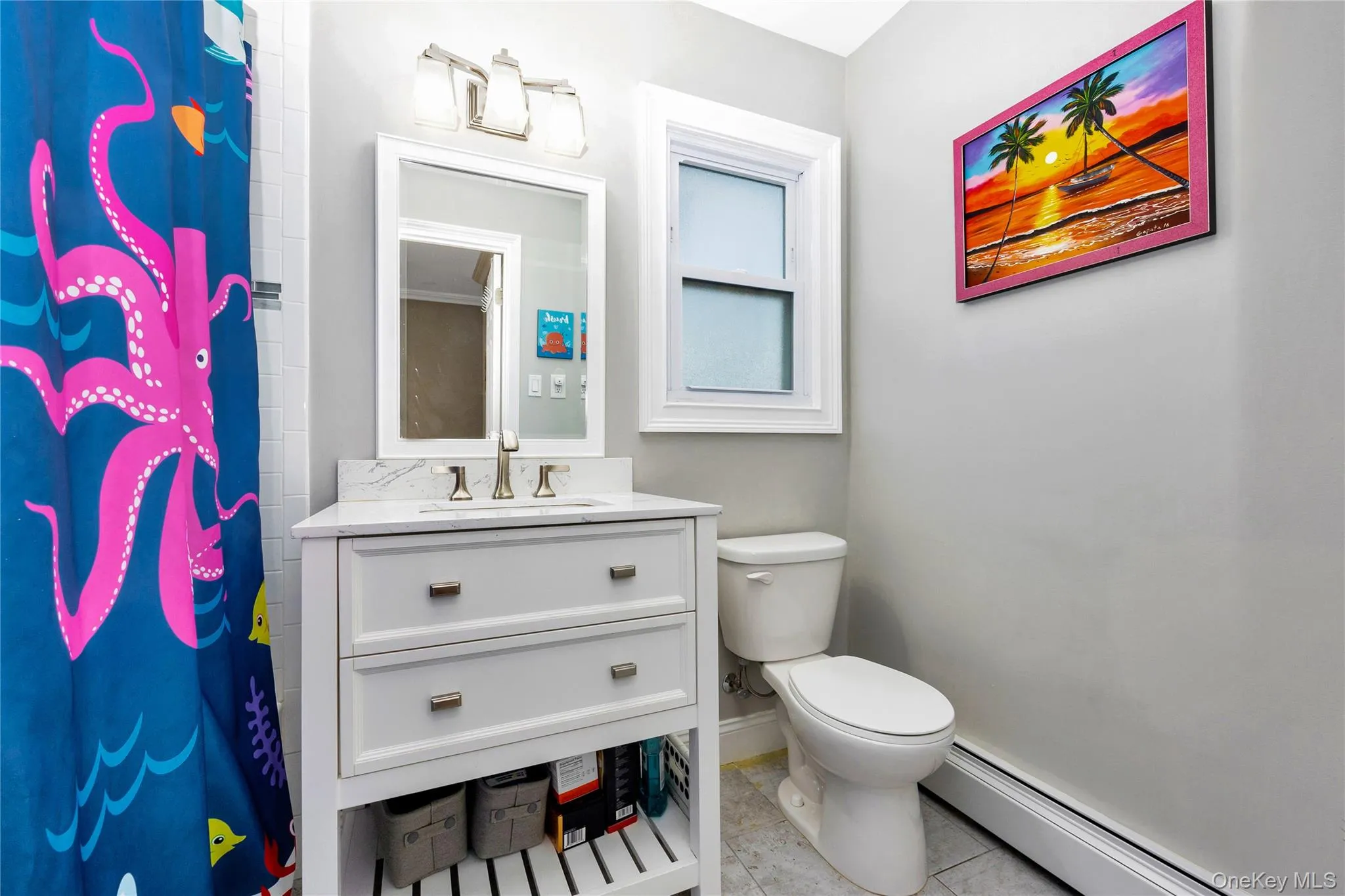 Bathroom featuring a baseboard heating unit, curtained shower, vanity, and light tile patterned flooring Bathroom featuring a baseboard heating unit, curtained shower, vanity, and light tile patterned flooring