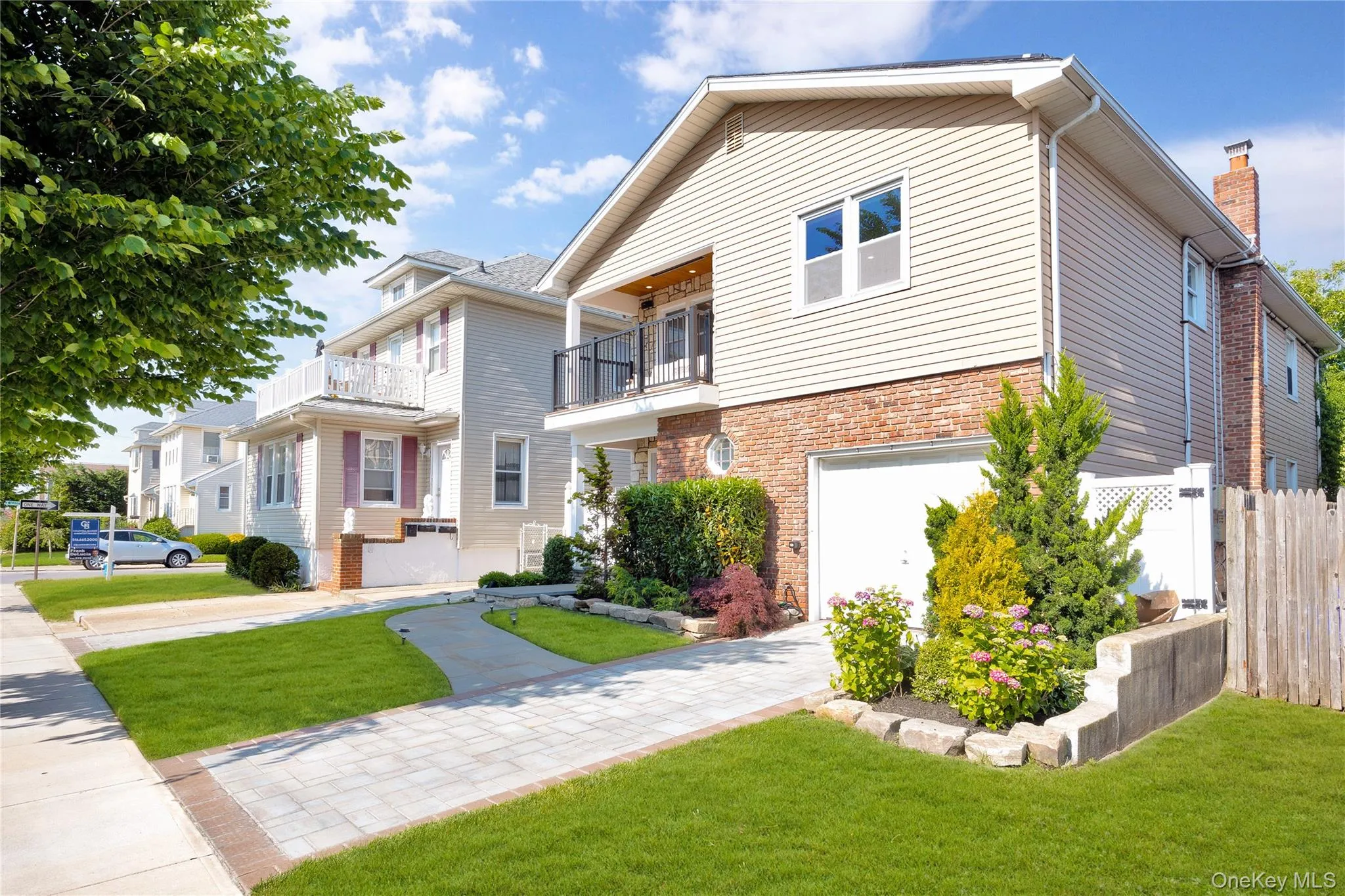 View of front of property with a balcony and brick siding View of front of property with a balcony and brick siding