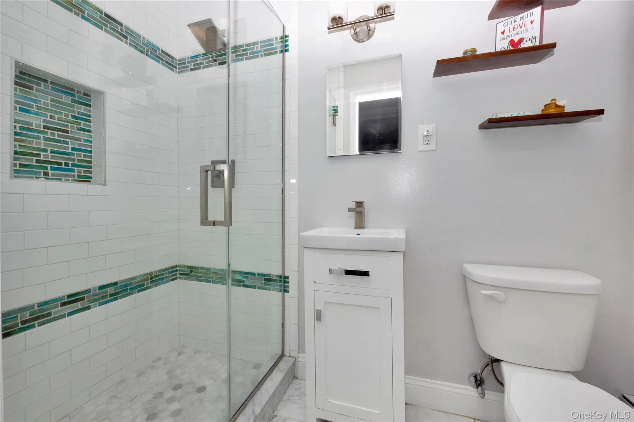 Full bathroom featuring vanity and a stall shower Full bathroom featuring vanity and a stall shower