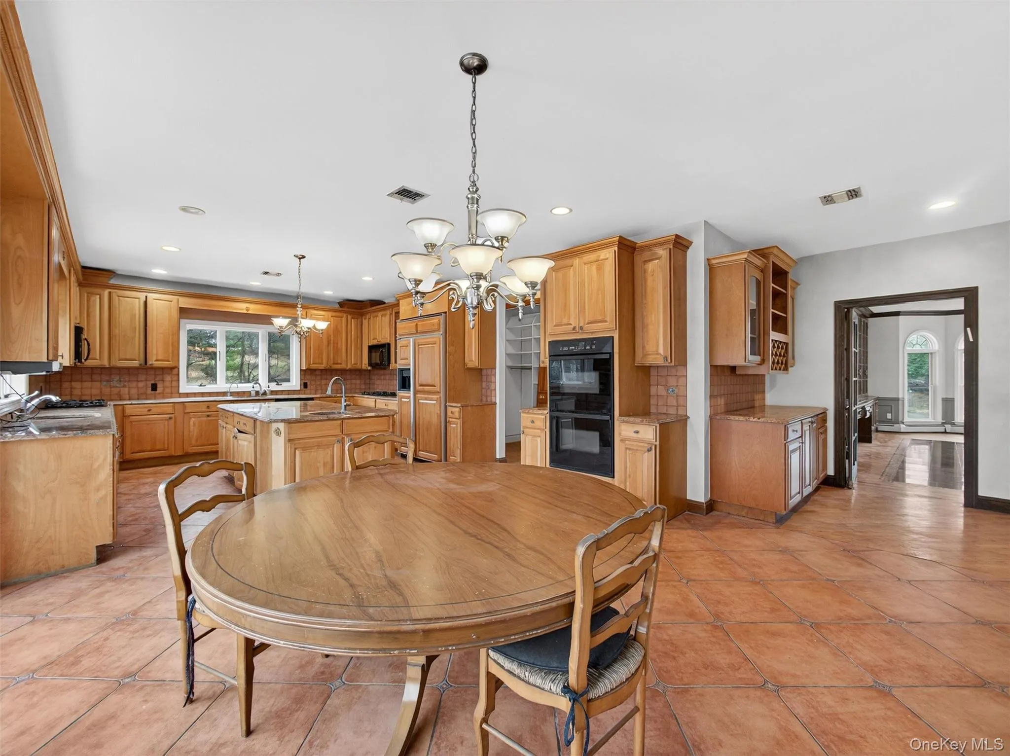 Dining space with a chandelier and recessed lighting Dining space with a chandelier and recessed lighting