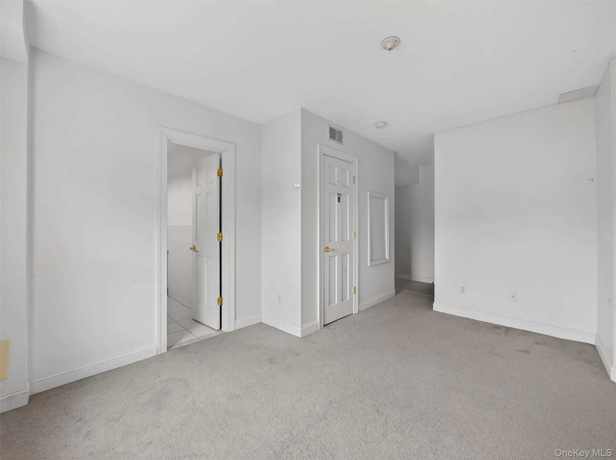 Unfurnished bedroom featuring carpet floors and baseboards Unfurnished bedroom featuring carpet floors and baseboards