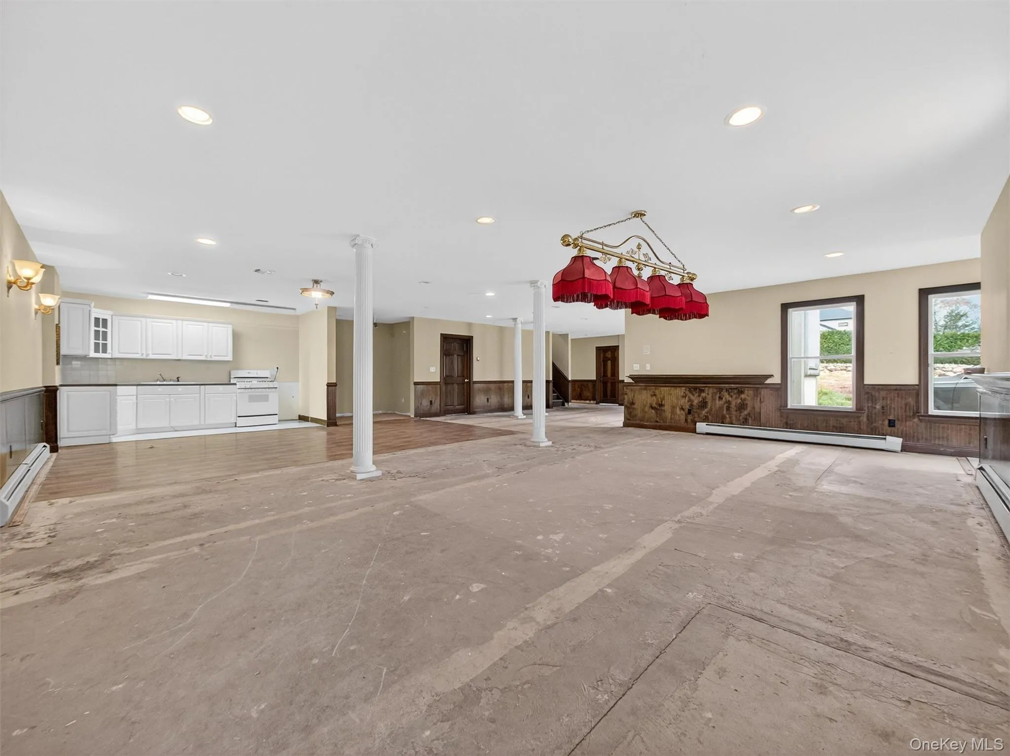 Unfurnished living room with wainscoting, a baseboard heating unit, and recessed lighting Unfurnished living room with wainscoting, a baseboard heating unit, and recessed lighting
