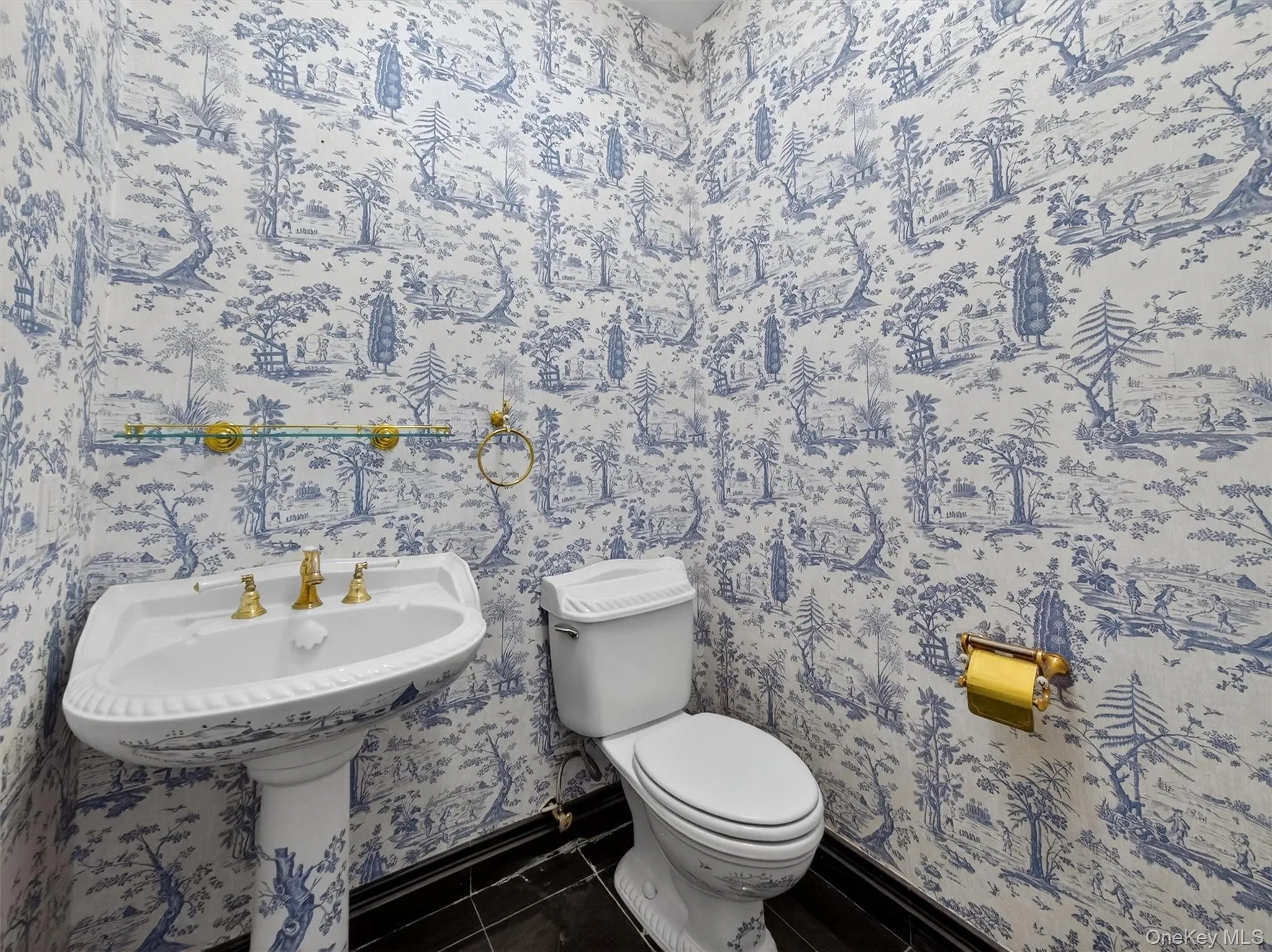 Half bath with toilet and tile patterned flooring Half bath with toilet and tile patterned flooring