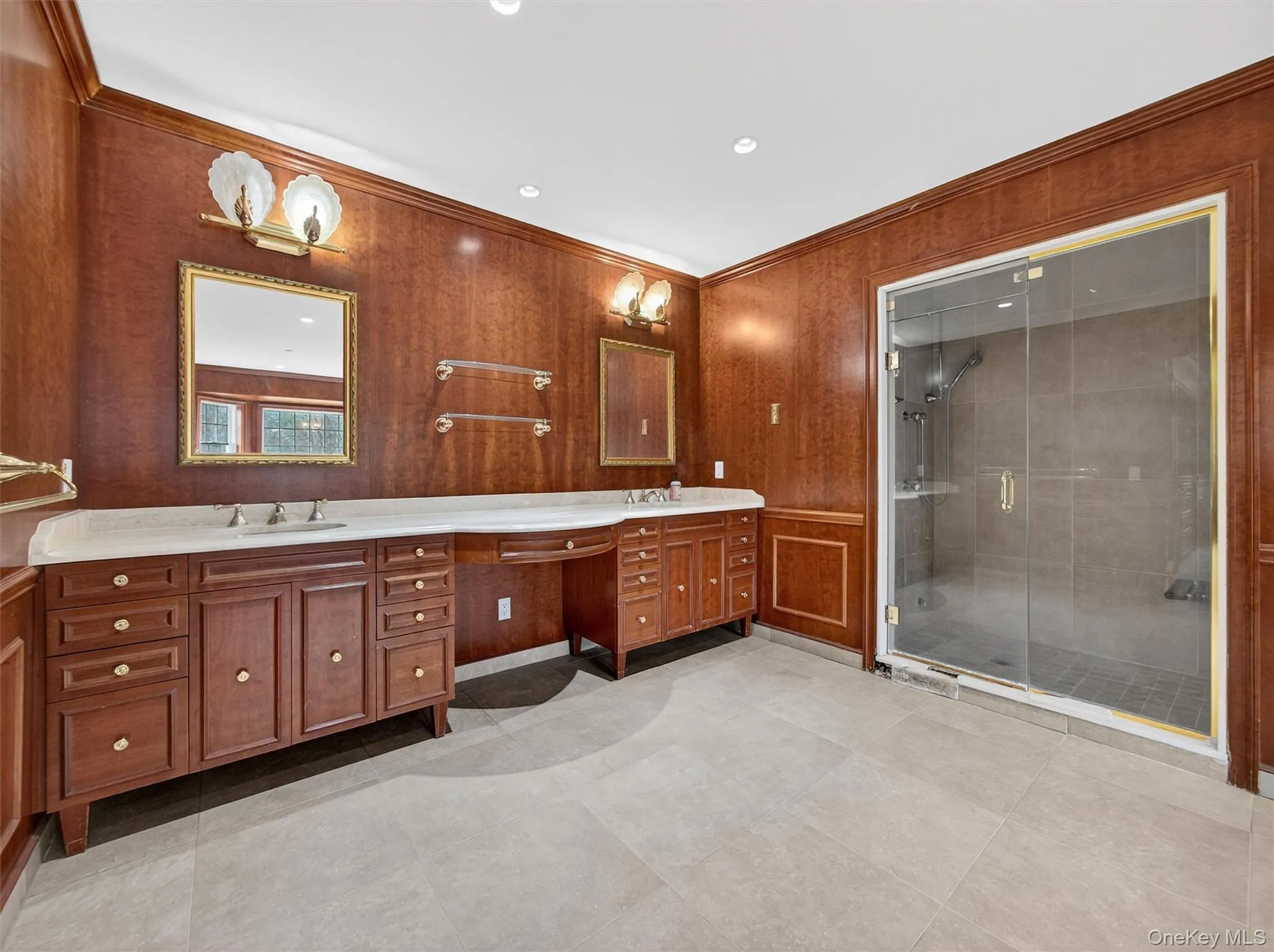 Bathroom with double vanity, a stall shower, crown molding, wooden walls, and recessed lighting Bathroom with double vanity, a stall shower, crown molding, wooden walls, and recessed lighting