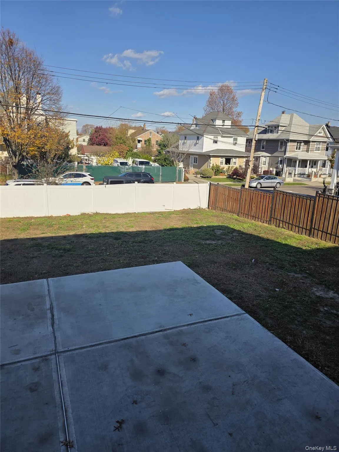 Fenced backyard featuring a residential view and a patio Fenced backyard featuring a residential view and a patio