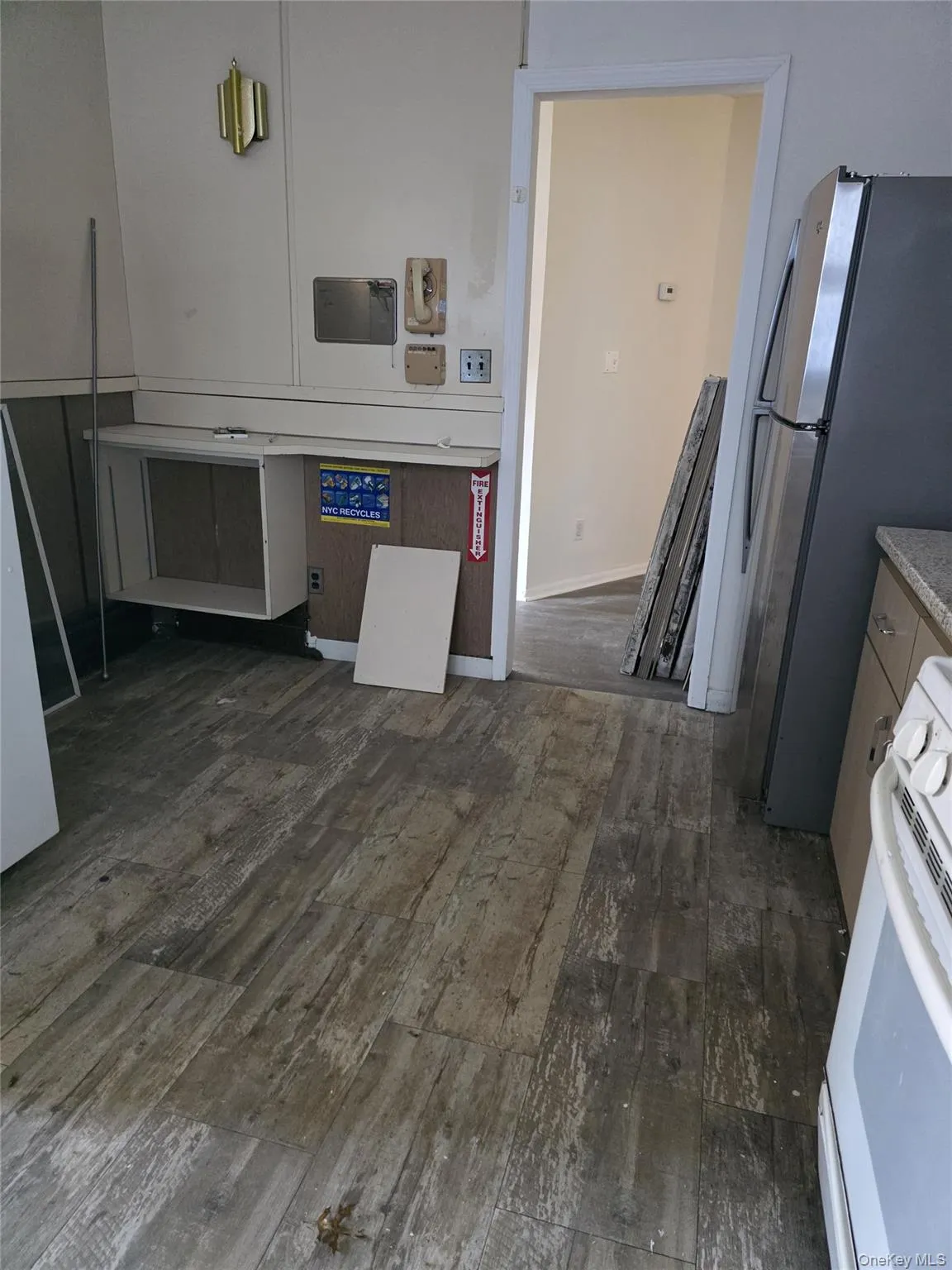 Kitchen with white range, freestanding refrigerator, and dark wood finished floors Kitchen with white range, freestanding refrigerator, and dark wood finished floors