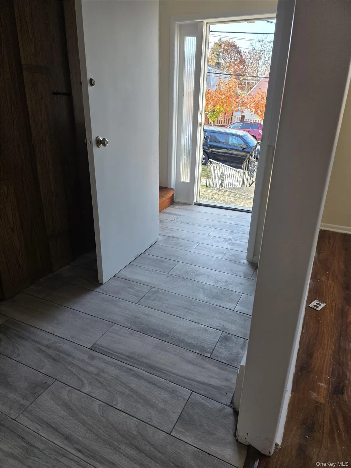 Corridor featuring wood tiled floors Corridor featuring wood tiled floors