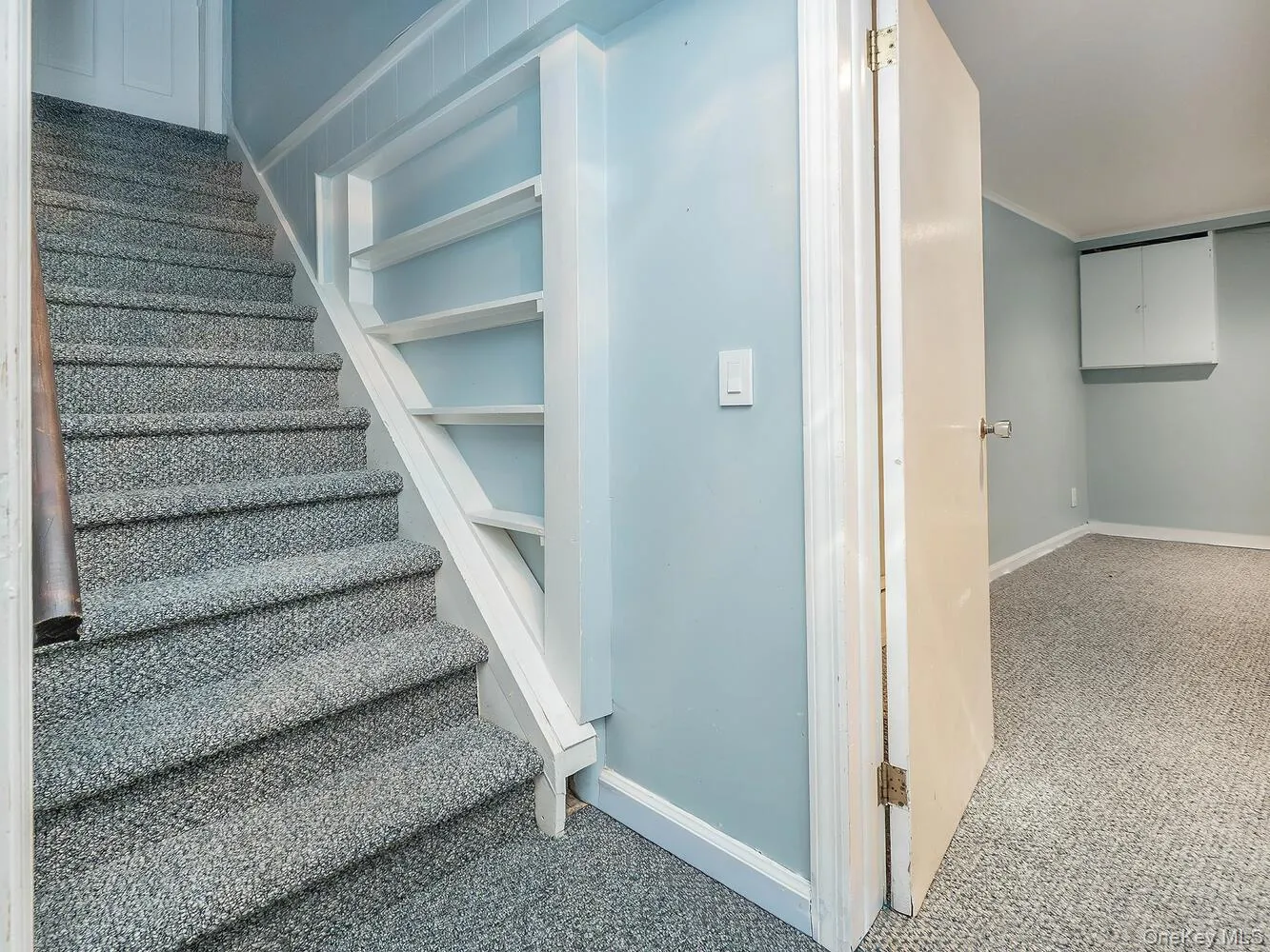 Stairs featuring carpet flooring and baseboards Stairs featuring carpet flooring and baseboards