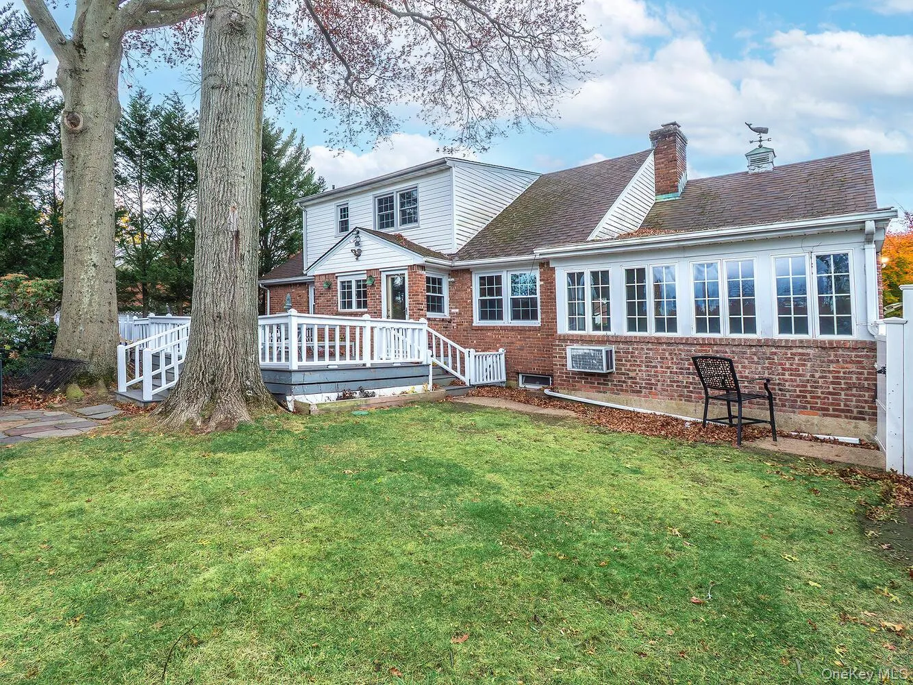 Back of house with a lawn, deck and pool Back of house with a lawn, deck and pool