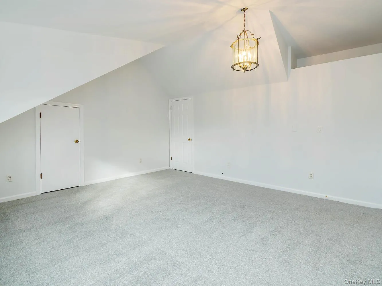 Bedroom with vaulted ceiling, light carpet, and a chandelier Bedroom with vaulted ceiling, light carpet, and a chandelier