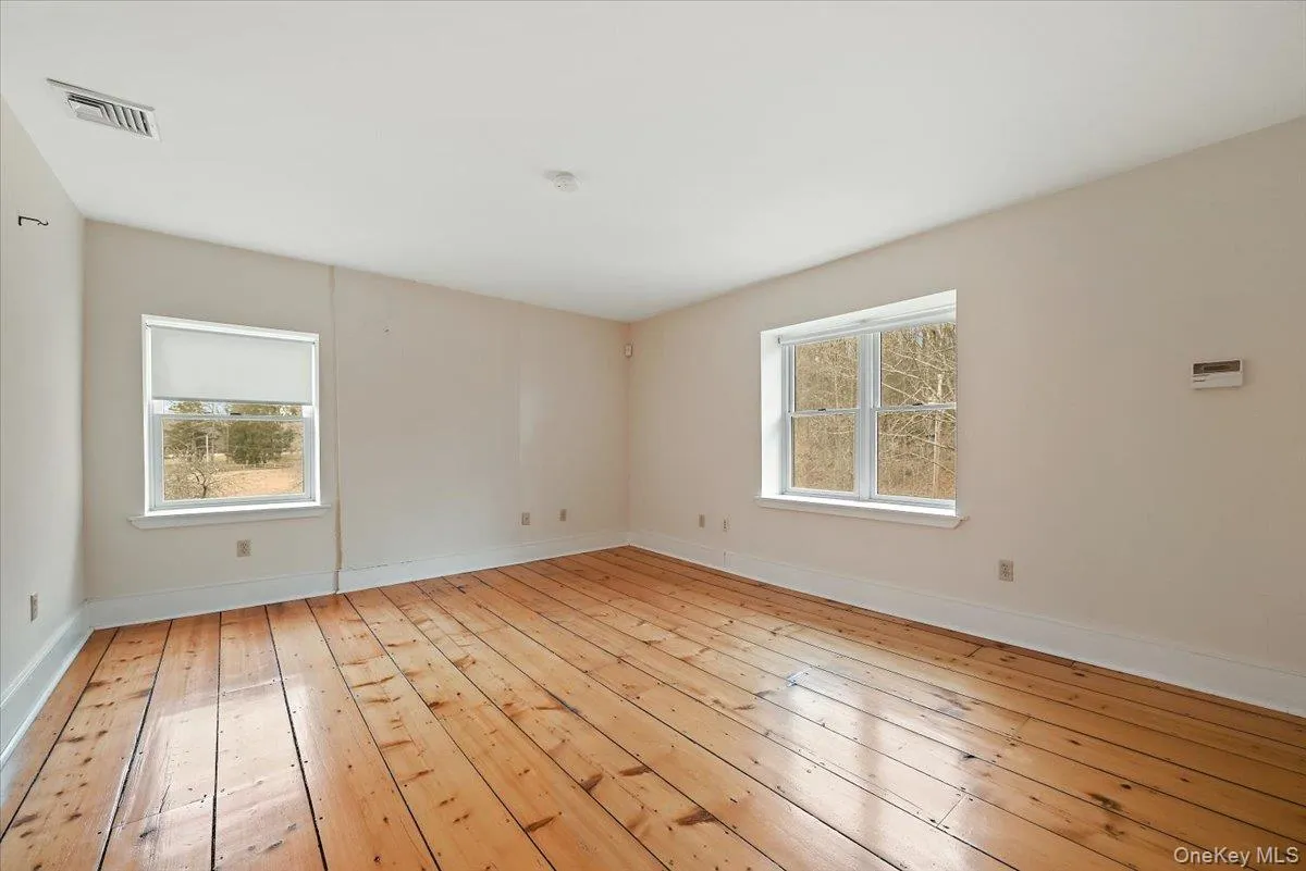 Unfurnished room featuring light wood-type flooring and baseboards Unfurnished room featuring light wood-type flooring and baseboards