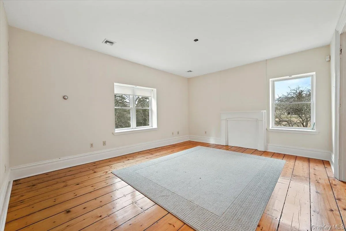 Unfurnished room featuring light wood finished floors Unfurnished room featuring light wood finished floors