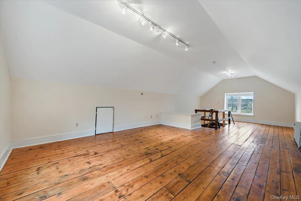Additional living space with lofted ceiling and light wood-type flooring Additional living space with lofted ceiling and light wood-type flooring