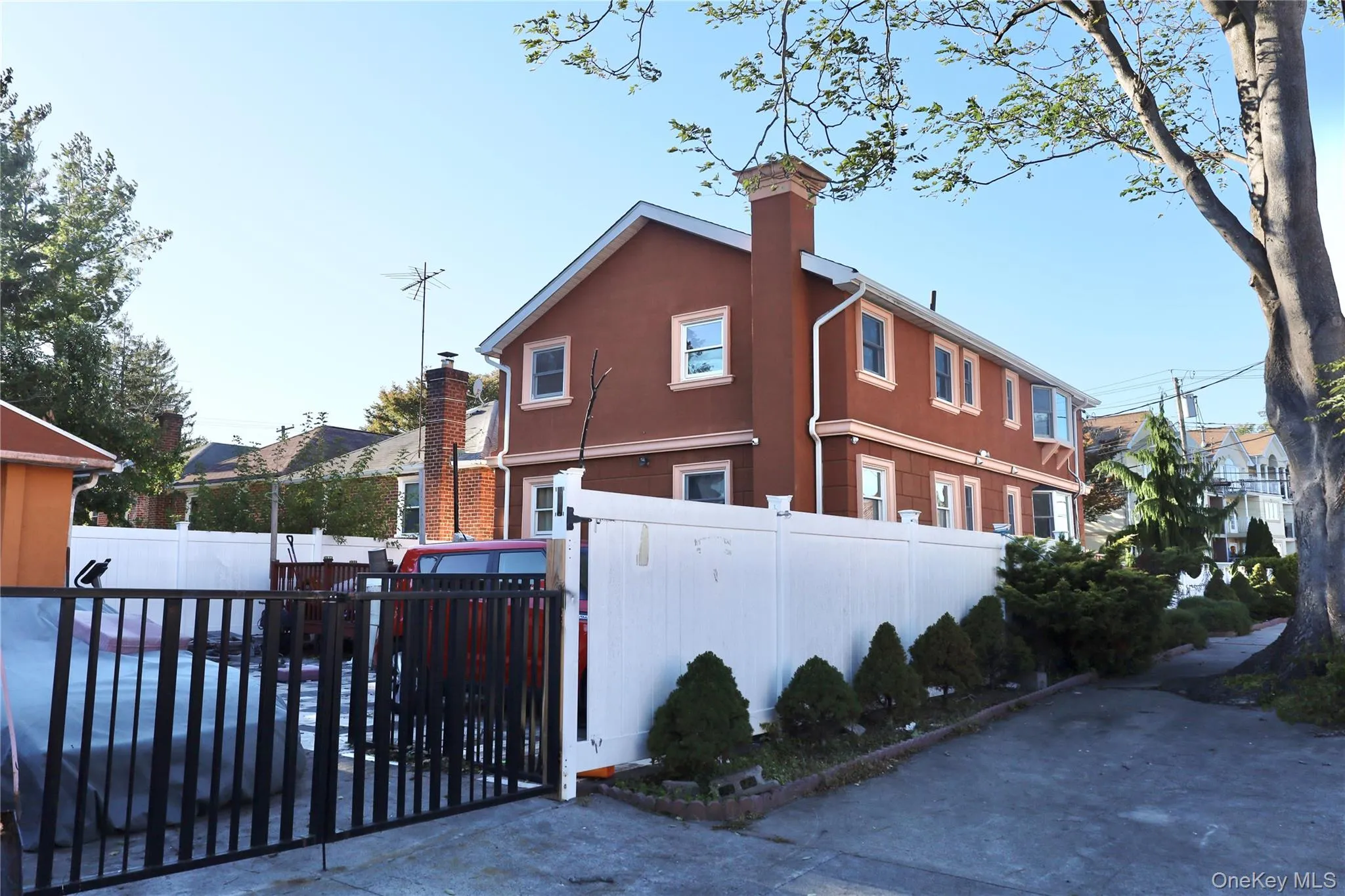 View of property exterior featuring a chimney and stucco siding View of property exterior featuring a chimney and stucco siding