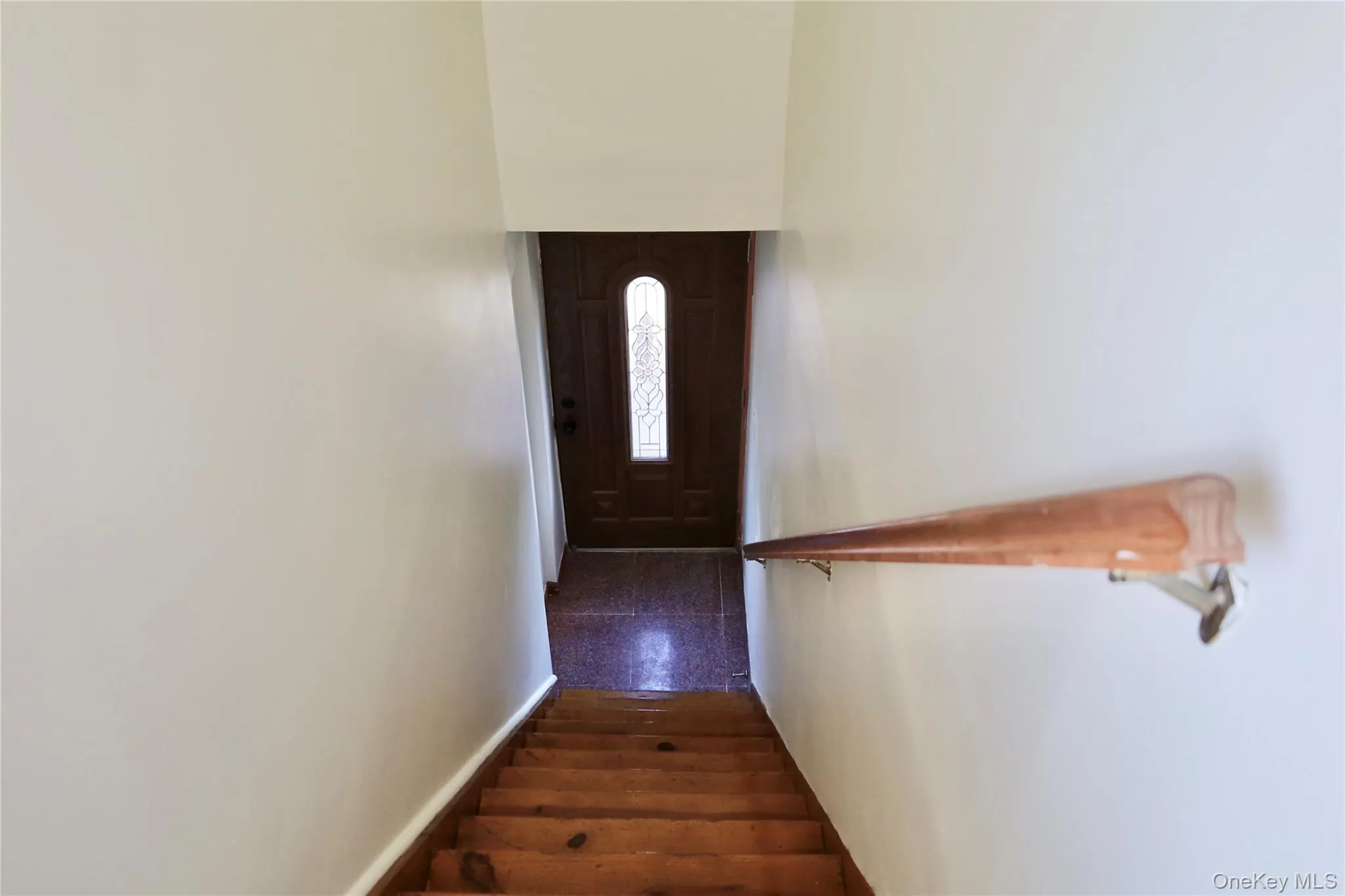 Staircase featuring baseboards Staircase featuring baseboards