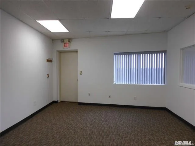 Spare room with dark carpet and a paneled ceiling Spare room with dark carpet and a paneled ceiling