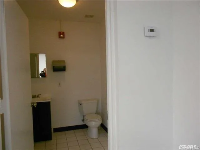 Bathroom with vanity and light tile patterned flooring Bathroom with vanity and light tile patterned flooring